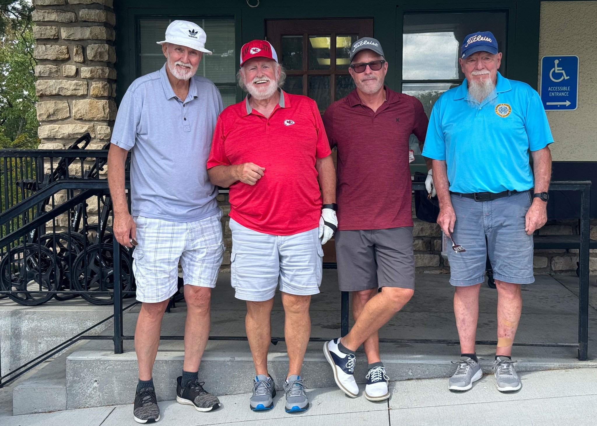 Four participants photographed together at the ArtsTech golf tournament