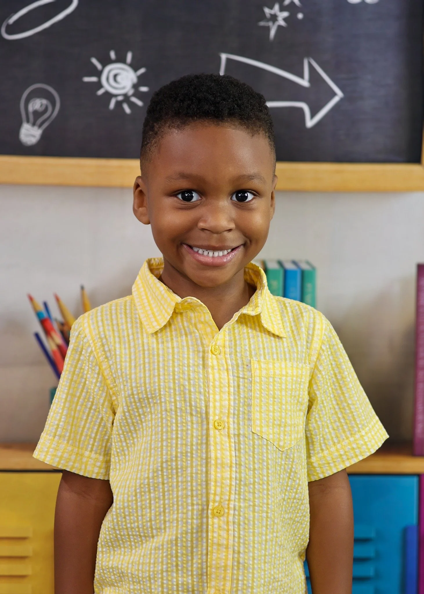 Smiling school portrait against a colorful classroom backdrop