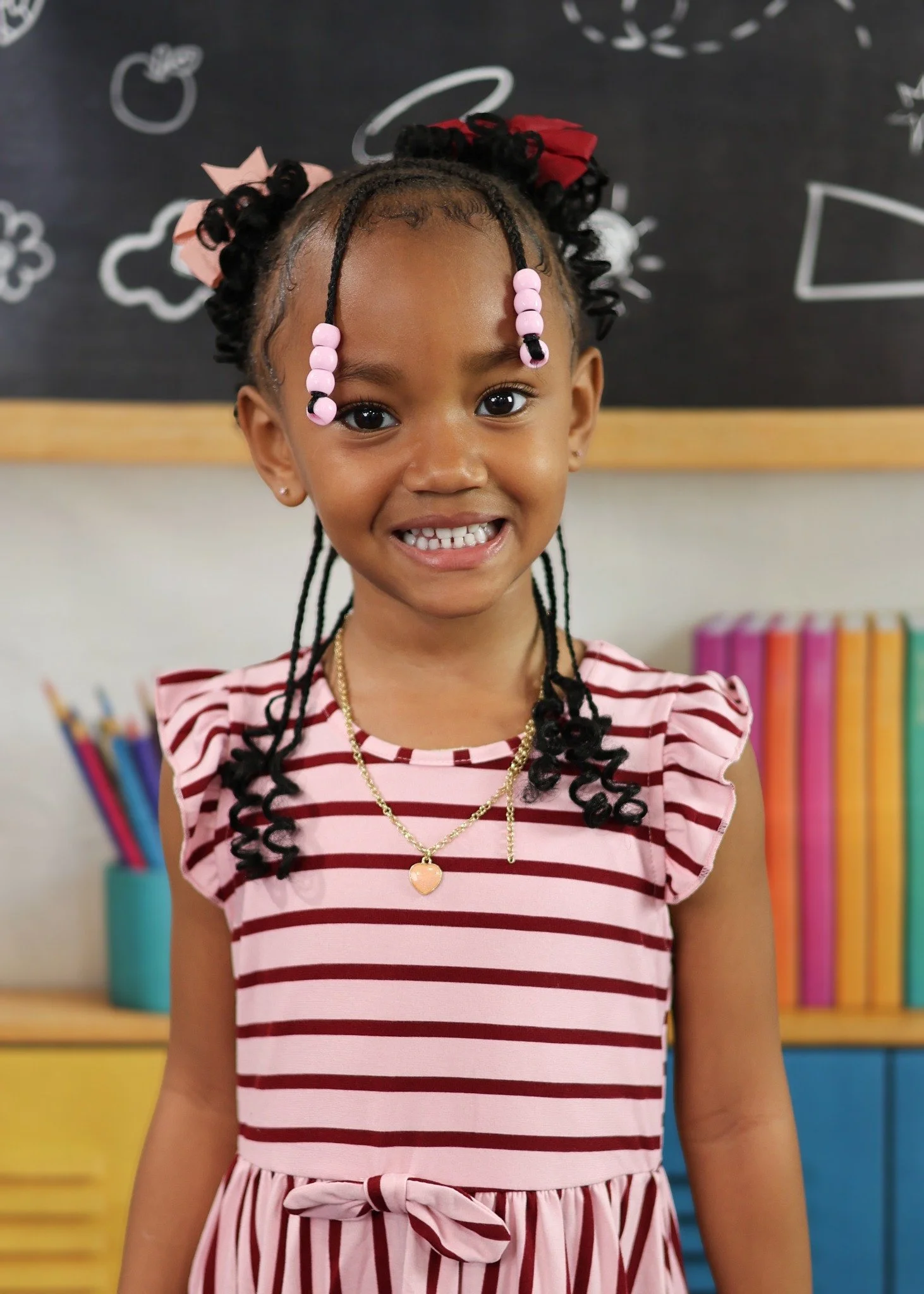 Smiling school portrait against a classroom backdrop.