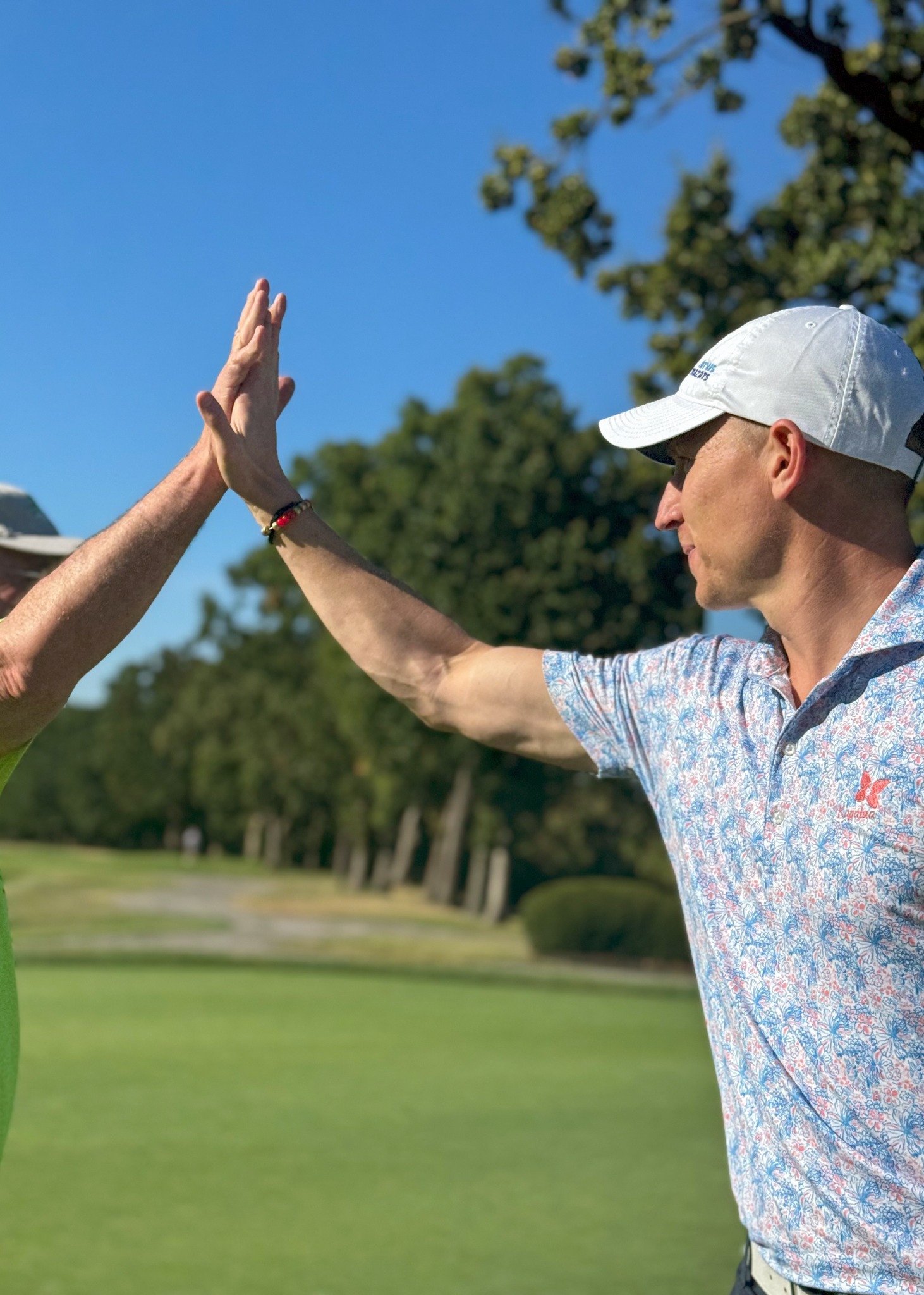 A high five on the golf course at the ArtsTech tournament.