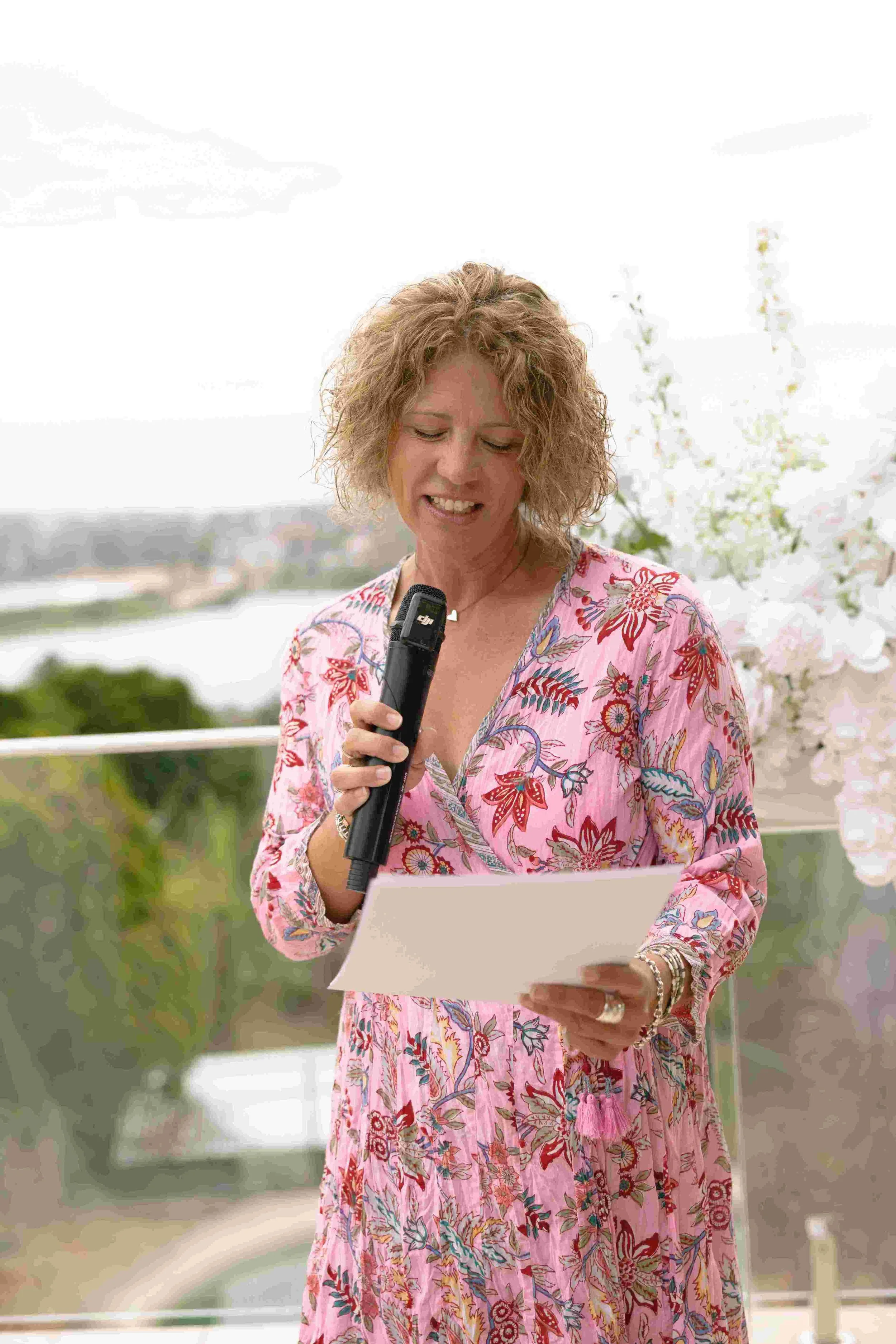 Marriage Celebrant Kate Cohen in floral dress conducting a wedding on a verandah on the Northern Beaches