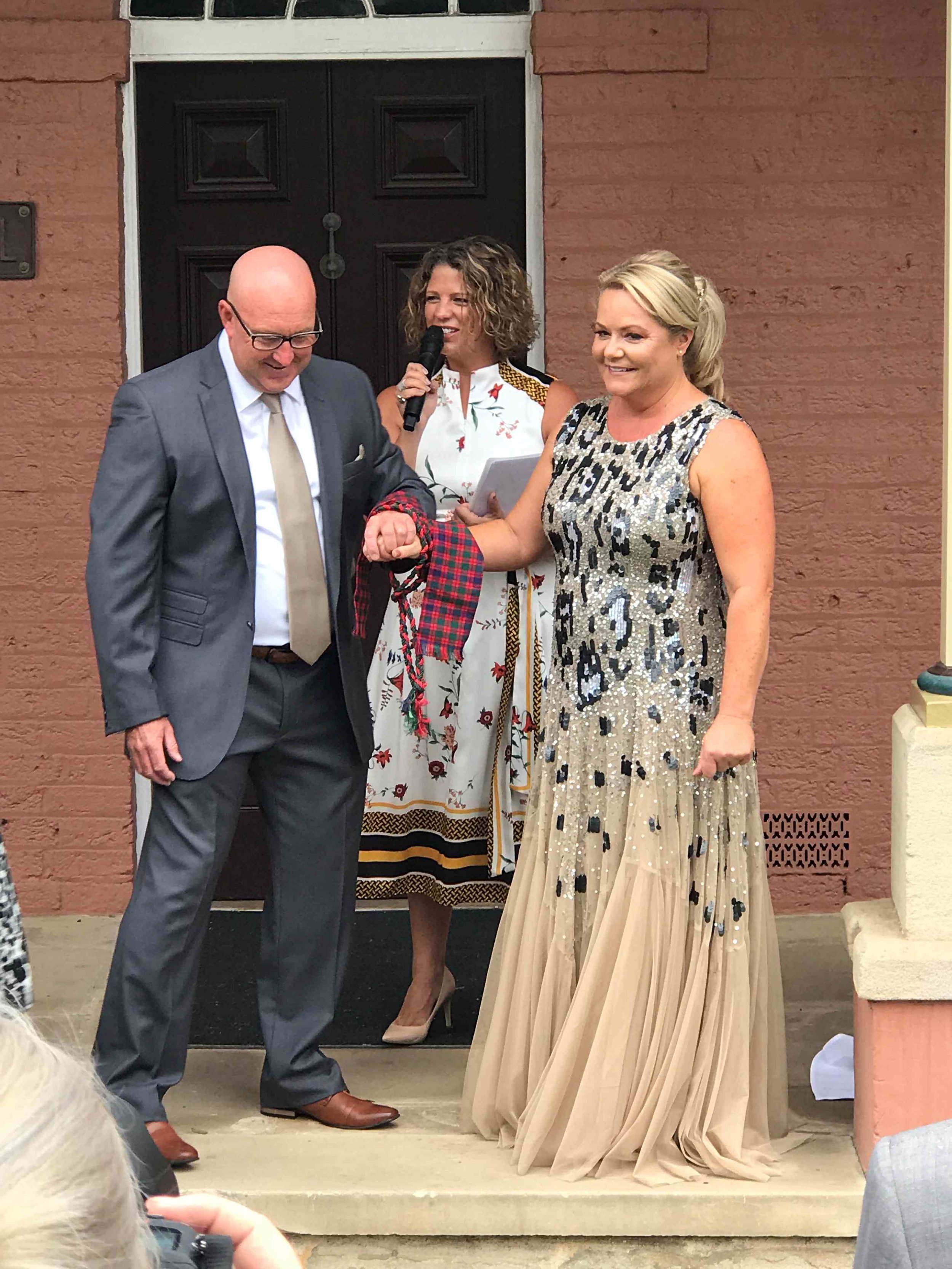 Marriage celebrant Kate Cohen officiating the ancient wedding ritual of handfasting