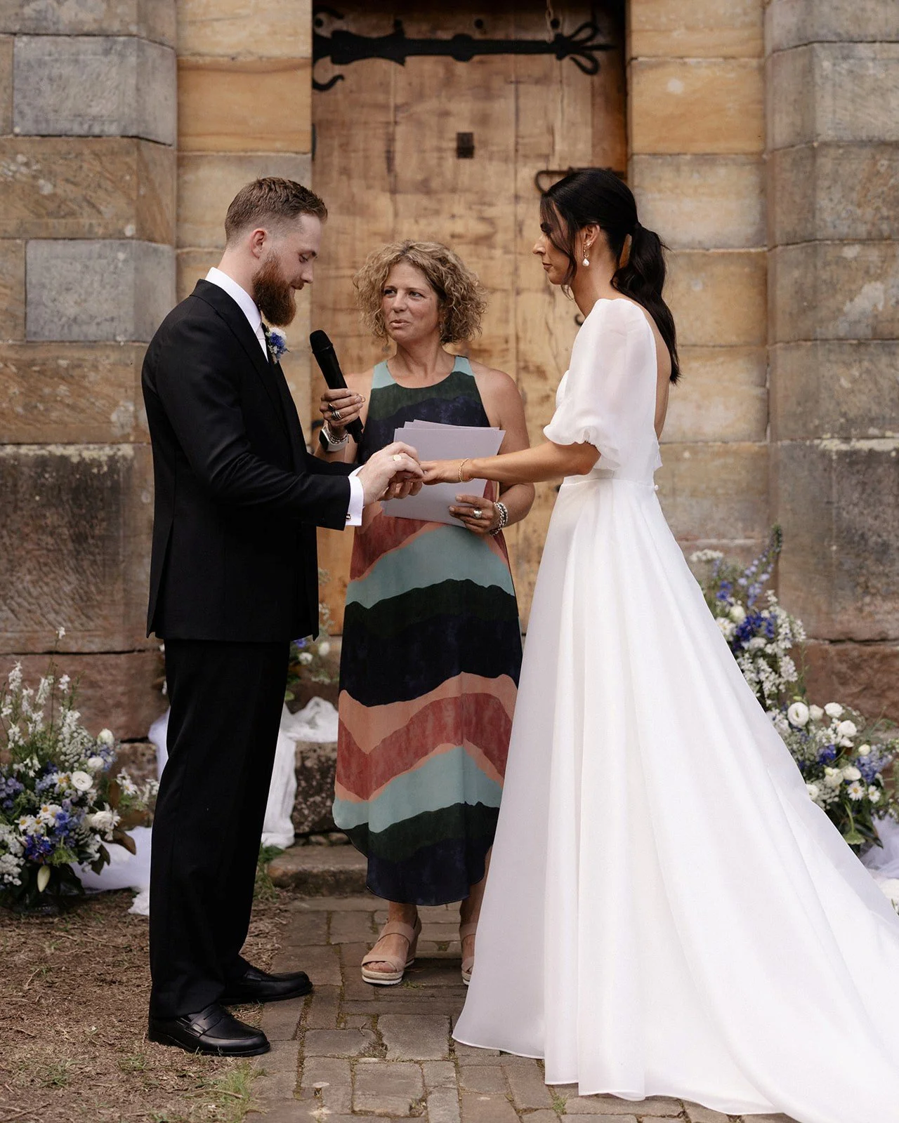 Sydney celebrant Kate Cohen conducting a vow renewal ceremony in an outdoor setting overlooking the Hawkesbury River at Wisemans Ferry