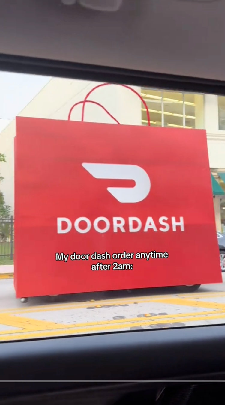 A large red Doordash sign with the company's logo, displayed outside a restaurant, with a caption saying "My door dash order anytime after 2am".