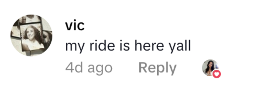 Screenshot of a social media comment from user 'vic' saying 'my ride is here yall' with a reply from a user with a profile picture of a woman.