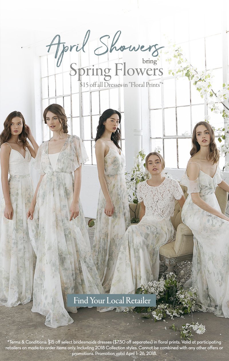 Five women wearing floral print dresses in a bright studio with large windows and white walls, promoting spring wedding dresses.