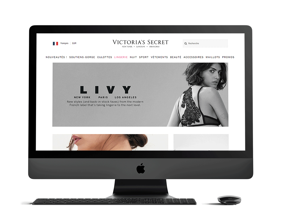 Computer monitor displaying Victoria's Secret website with lingerie and clothing images.