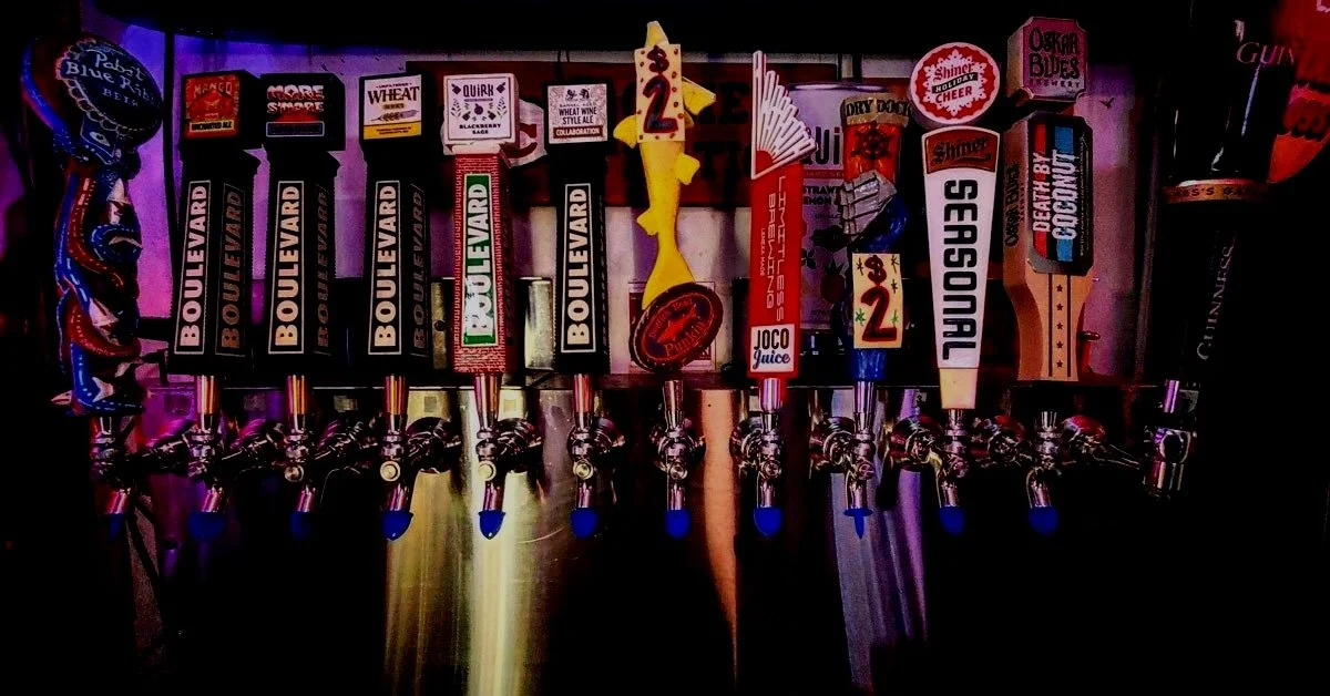Craft beer tap wall at 403 Club featuring colorful illuminated taps and rotating Kansas City draft selections.