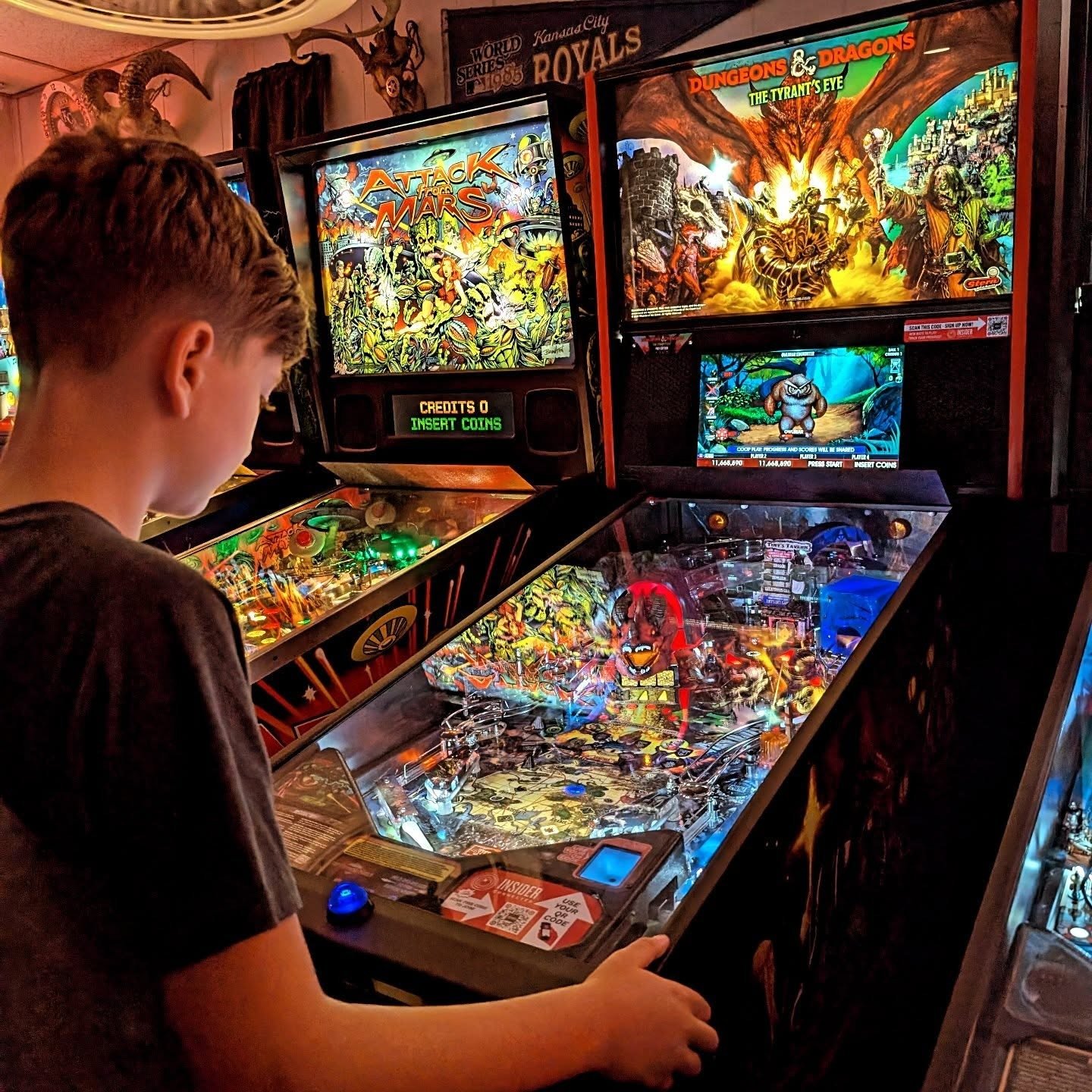 Brightly lit pinball machines inside 403 Club, Kansas City’s neighborhood pinball bar with rotating modern and classic titles.