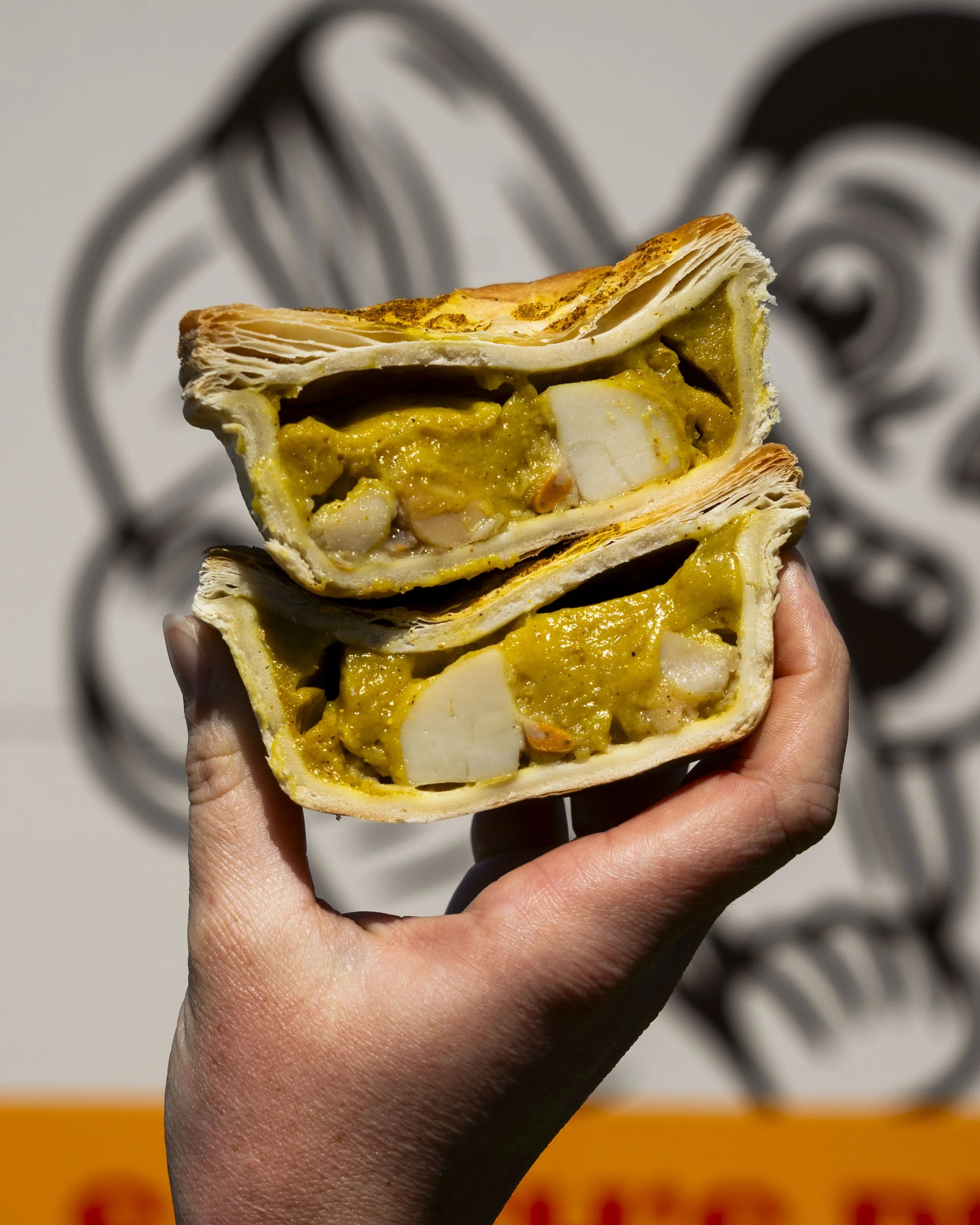 Smith's curried scallop pie cut open showing Tasmanian scallops and curry filling