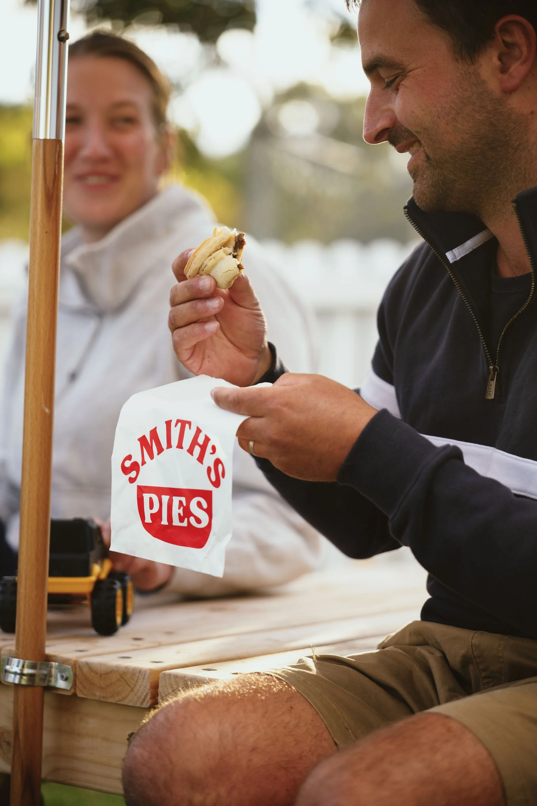 Customer enjoying a Smith's pie at the Pie Yard in Cambridge Tasmania