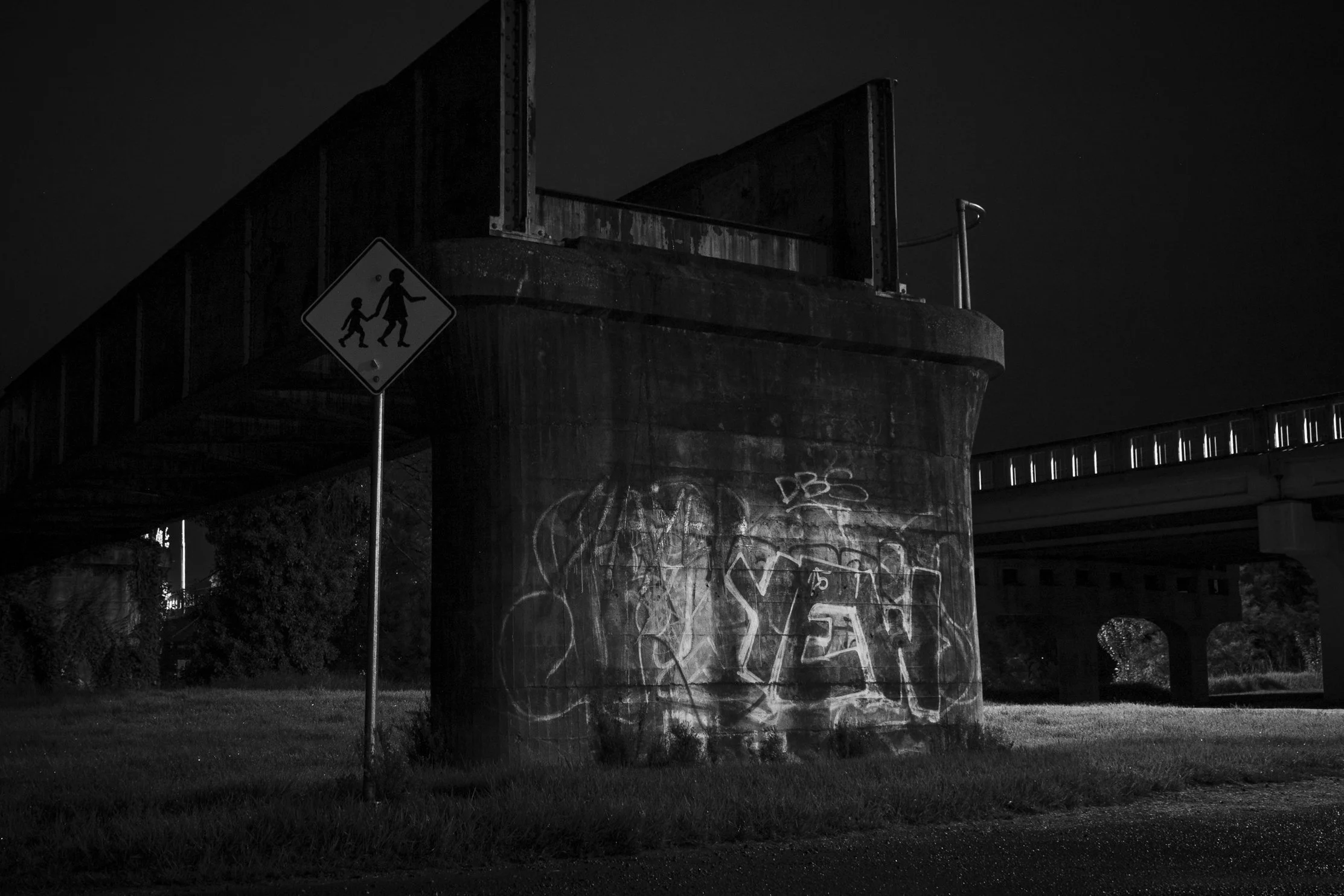 The old railway bridge over the Mitchell River, marked by graffiti and time.