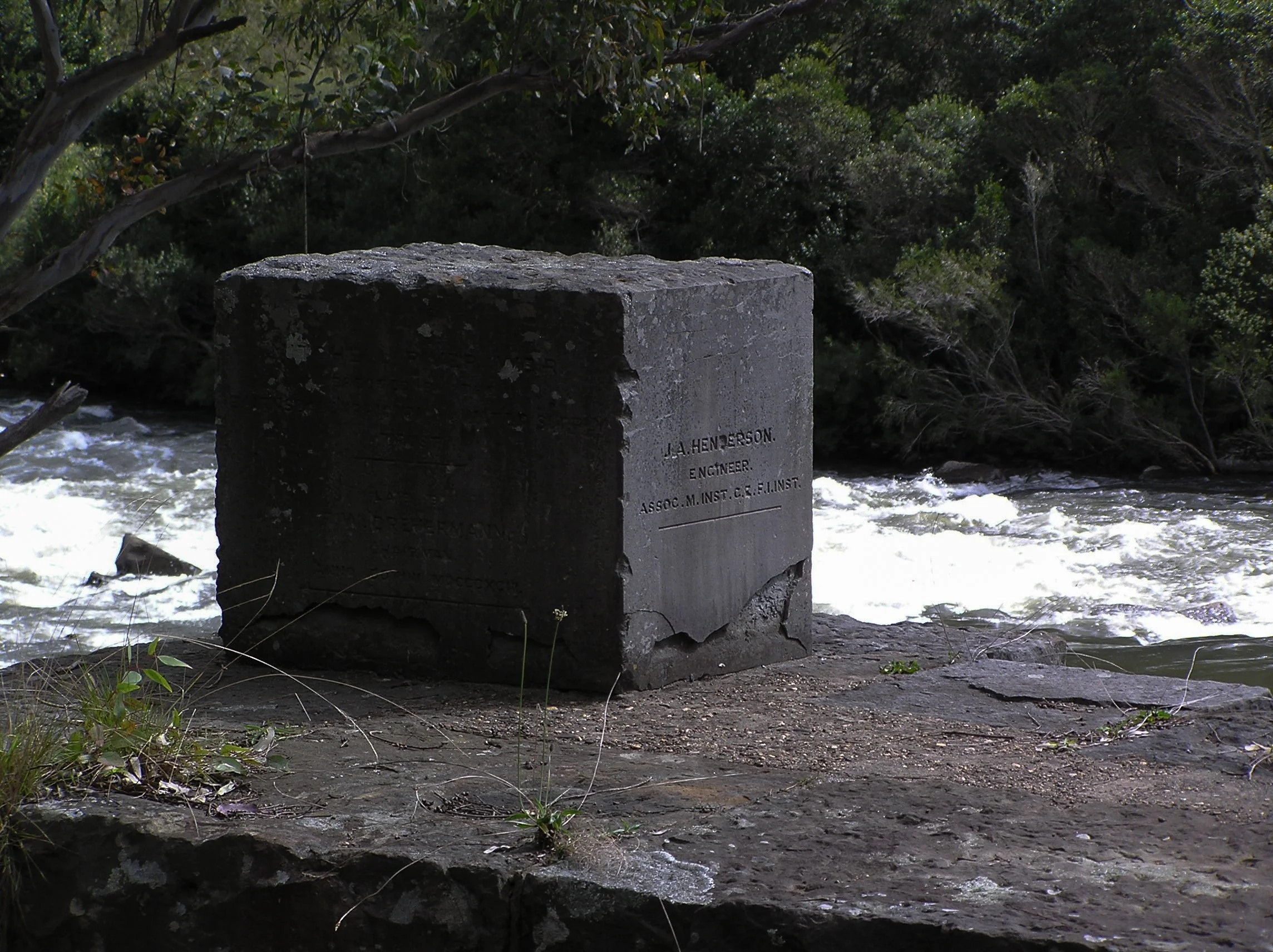 Engraved stone block at the Glenaladale Weir bearing the name J.A. Henderson, Engineer