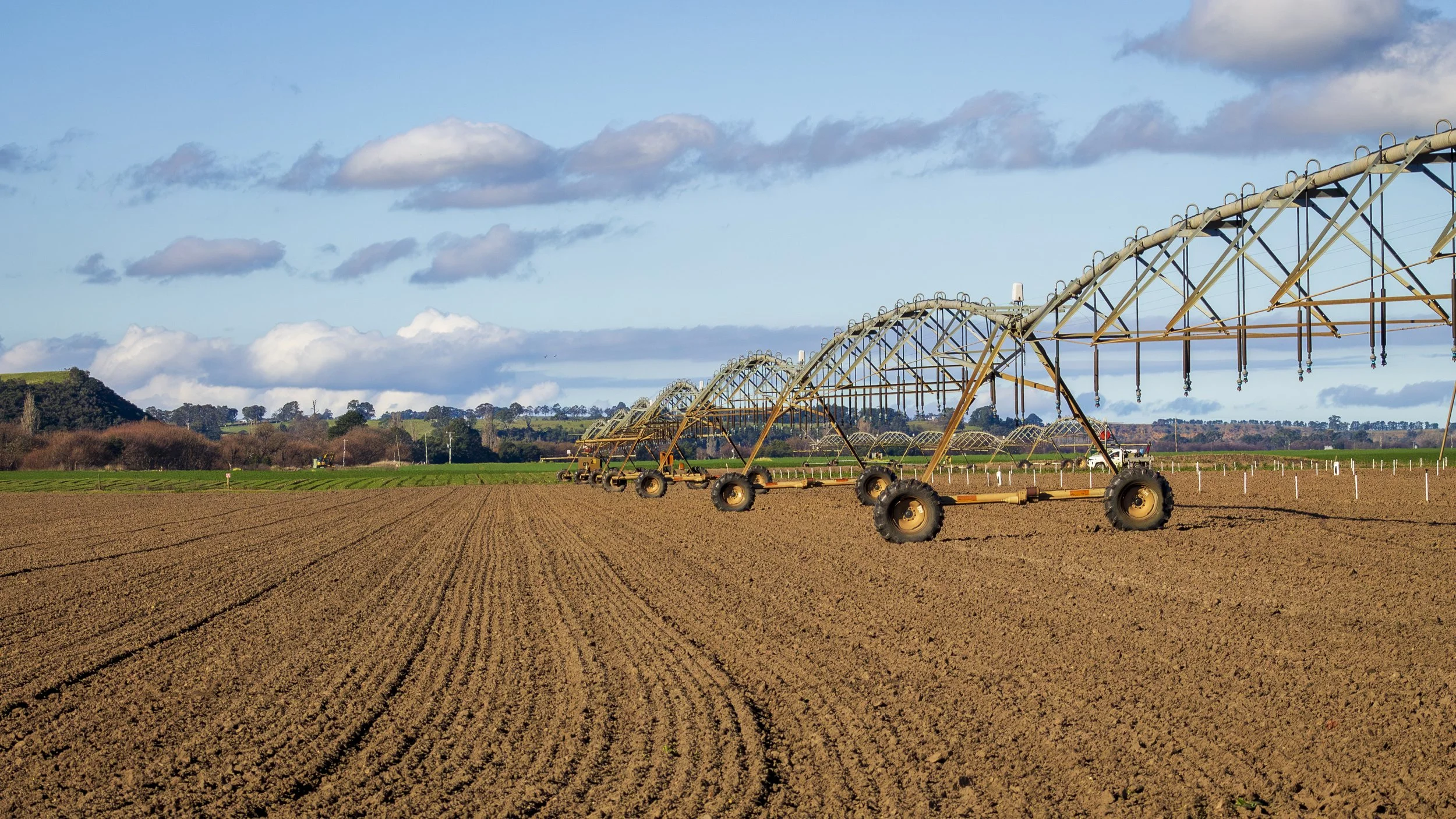 Irrigation equipment stretches across freshly cultivated farmland at Lindenow, in East Gippsland's fertile Gippsland Food Bowl, beneath a wide winter sky.