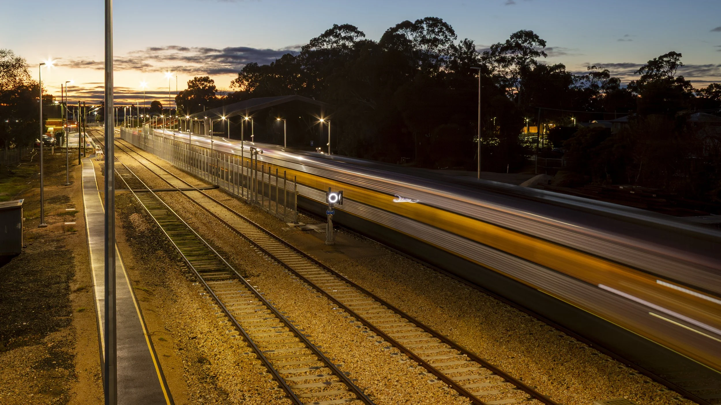 A train passes through Bairnsdale station at dawn.