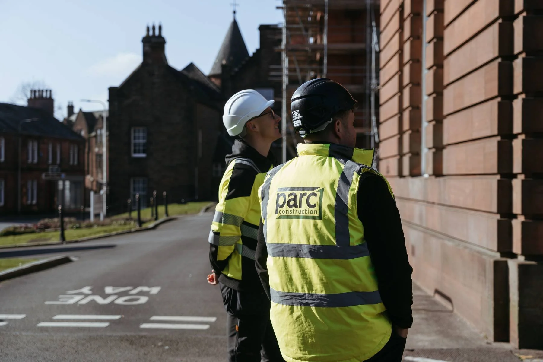 Parc Construction team members inspecting external building works on site in Dumfries and Galloway
