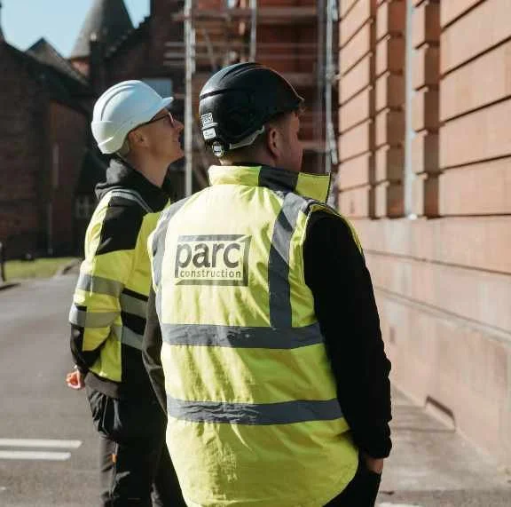 Parc Construction team members inspecting external building works on site in Dumfries and Galloway