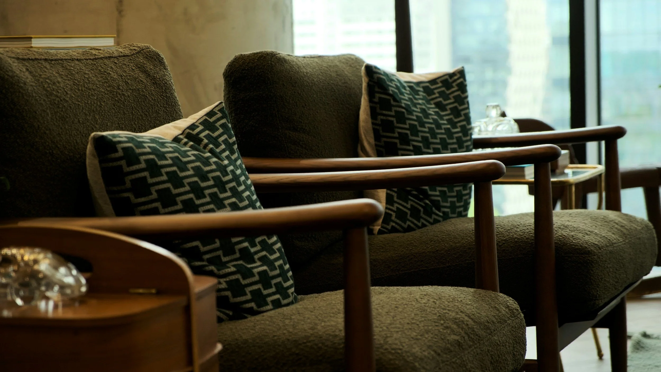 Two comfortable forest green chairs with cushions