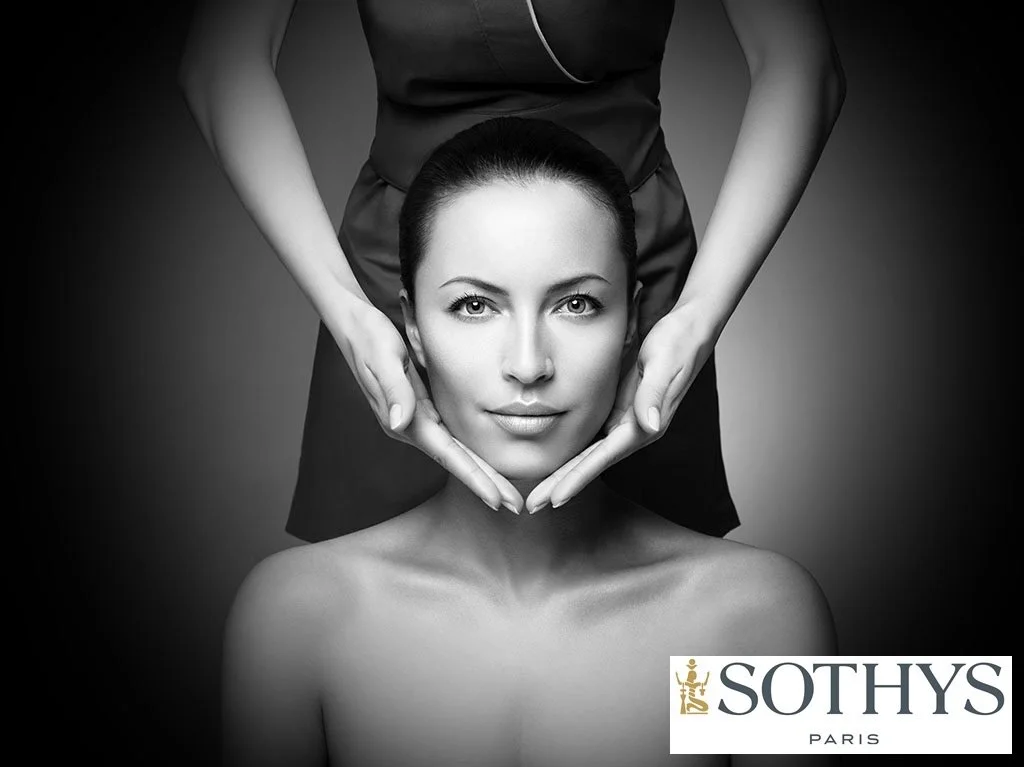 A woman receiving a facial massage from a professional in a black and white photo, with the Sothys Paris logo in the bottom right corner.