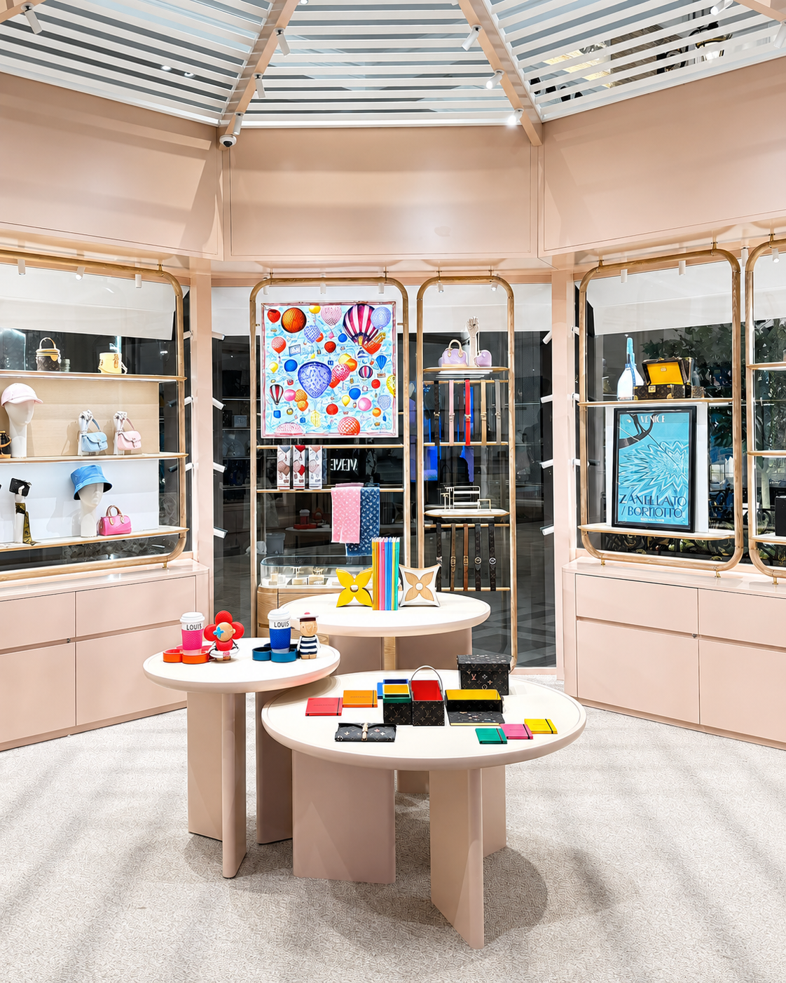 Display inside a retail store featuring handbags, accessories, and decorative items with colorful artwork on the walls.