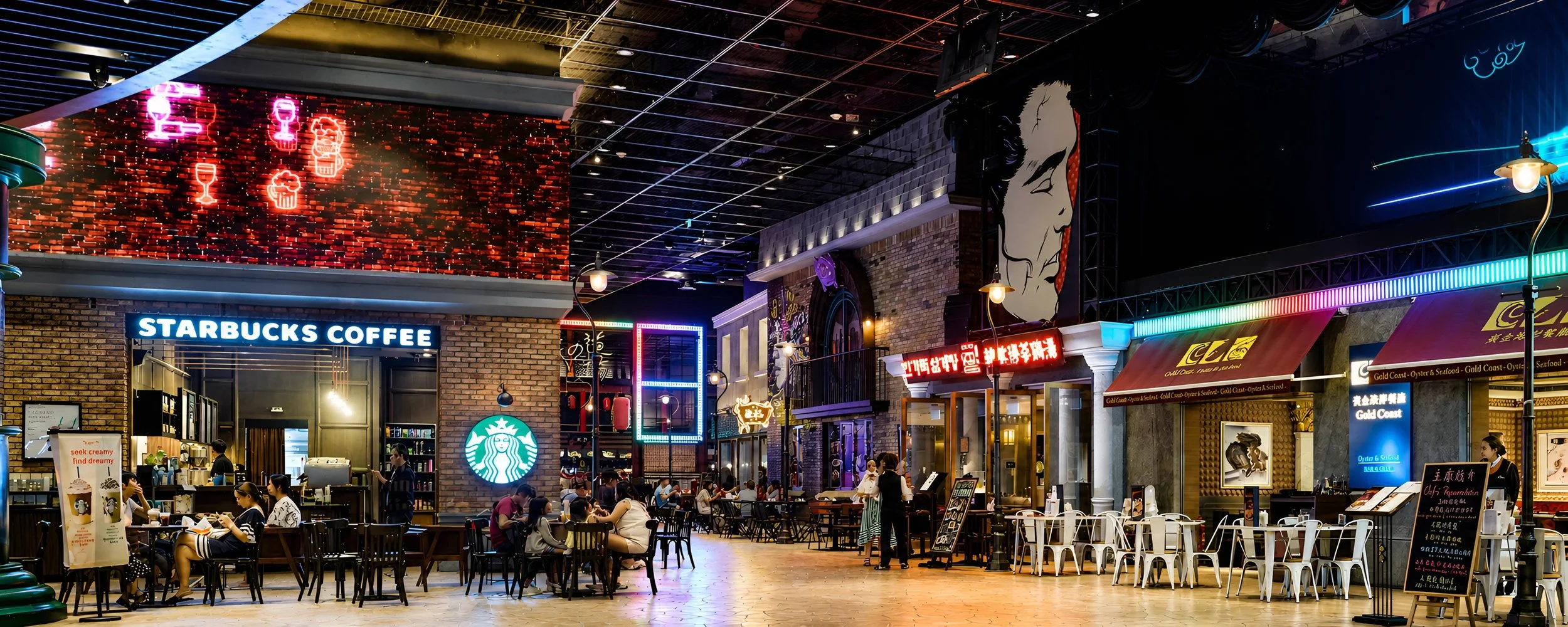A busy indoor shopping mall or food court with several dining options, including a Starbucks coffee shop and a seafood restaurant. The area features neon signs, bright lighting, and people sitting at tables eating and socializing.