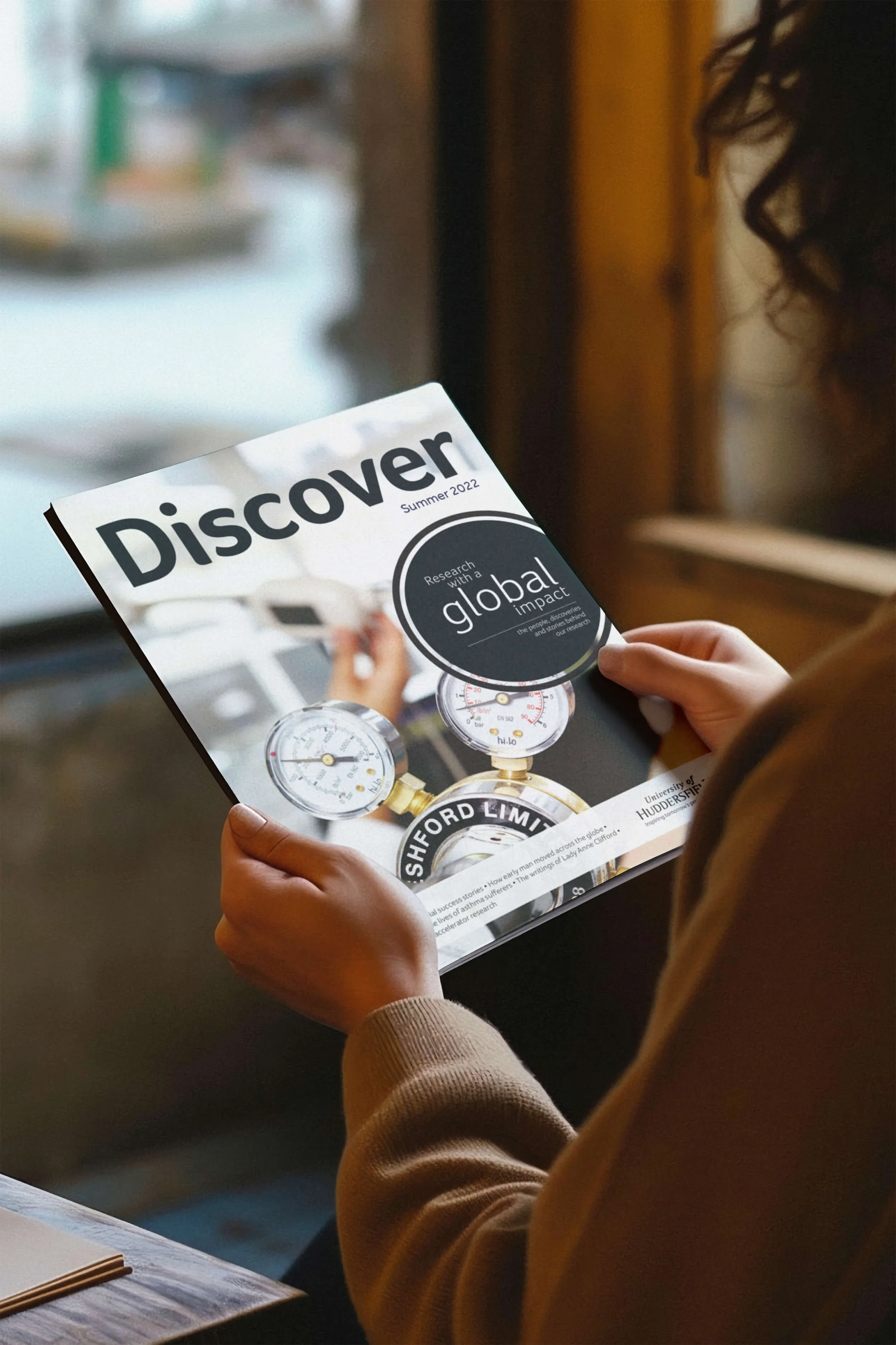 Young woman holding a Discover Magazine