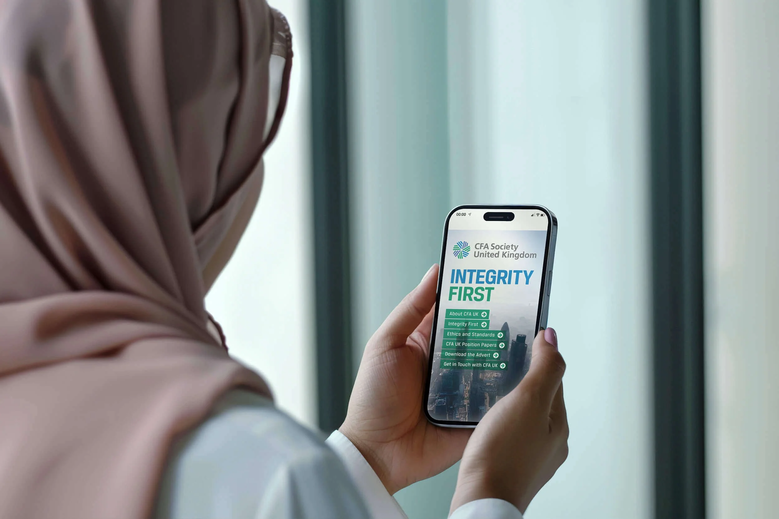 Image of woman looking at phone featuring the CFA website