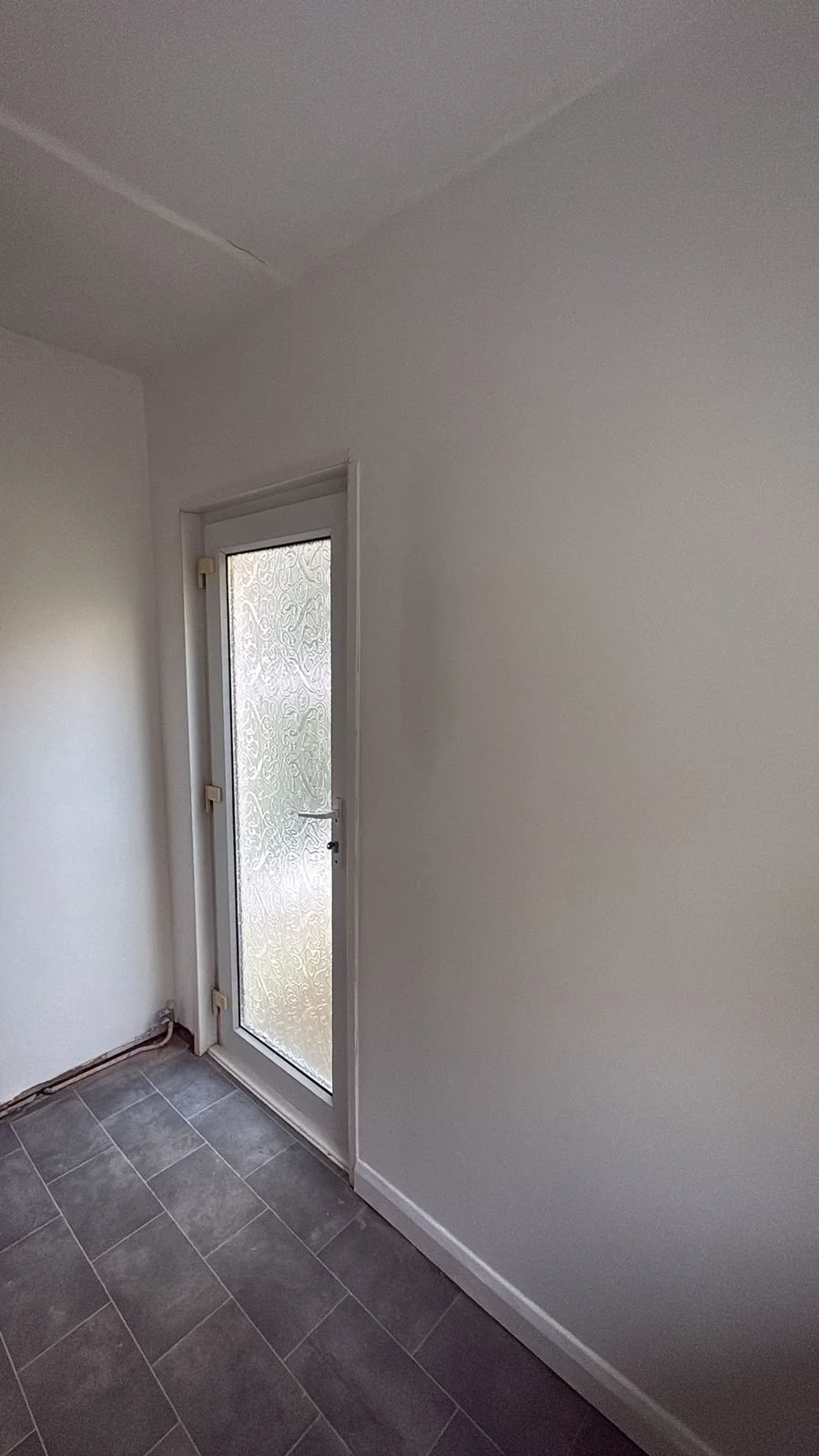After: hallway finish with slate-effect tiles and glazed door — Hastings