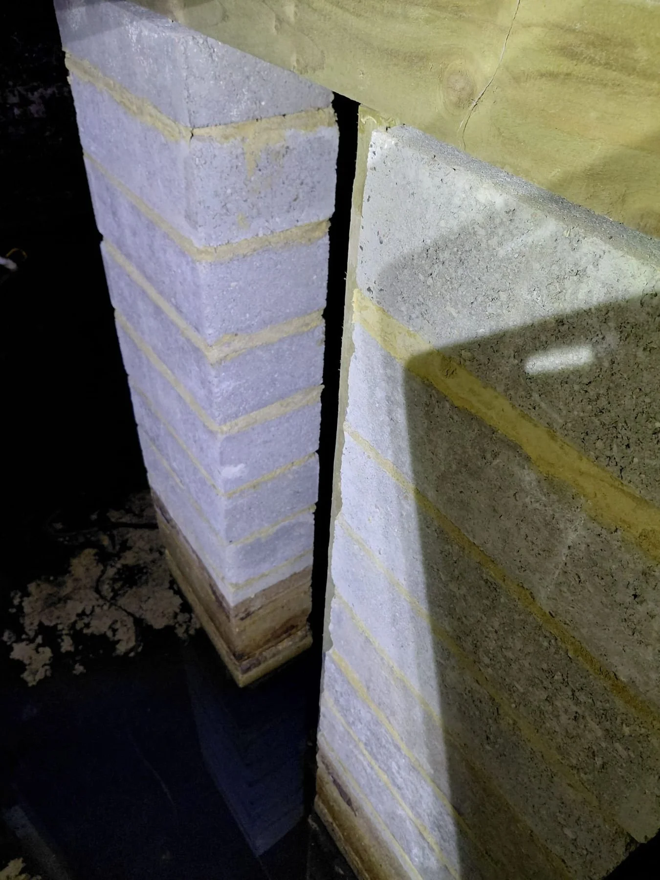 Before: structural pillars standing in flood water — Bexhill