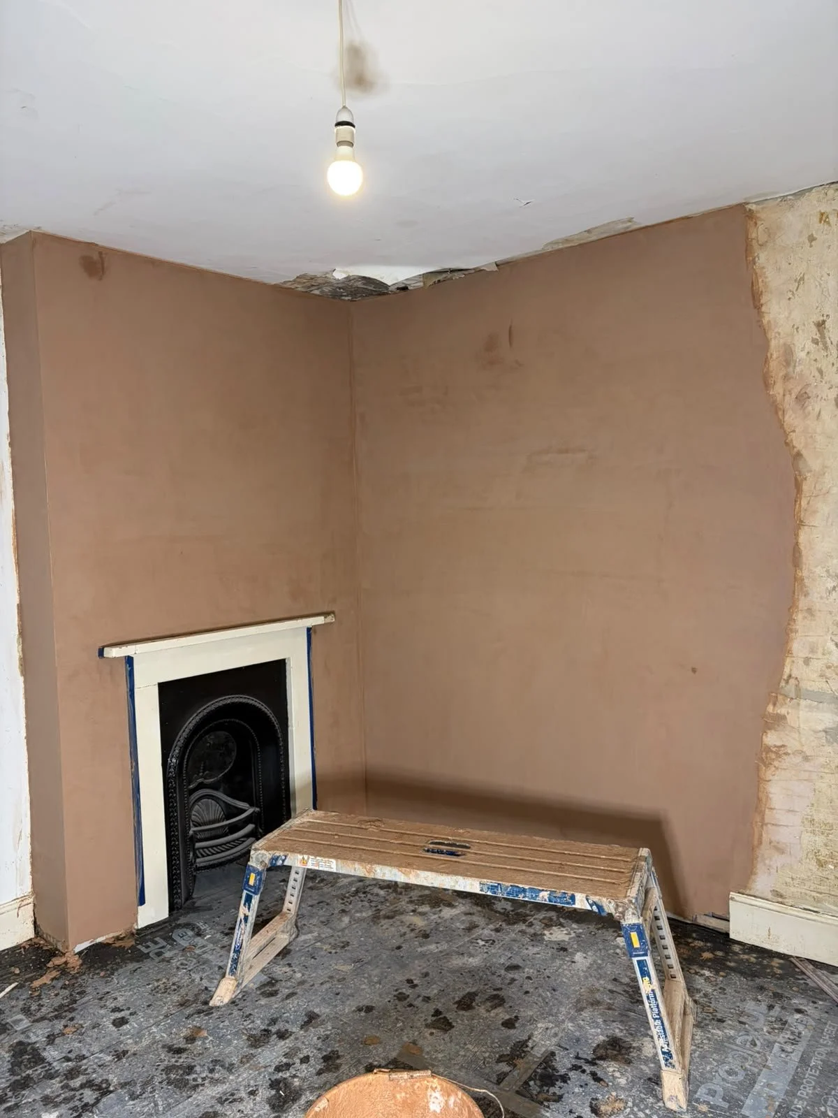 Chimney breast replastered and ready for client decoration.