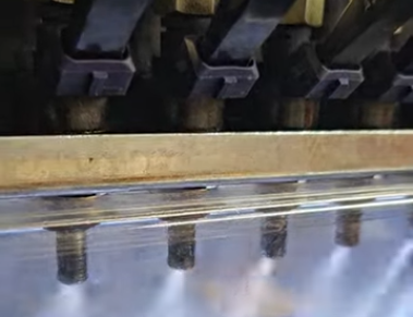 Close-up of a row injectors spraying at 100% duty cycle for spray pattern inspection.