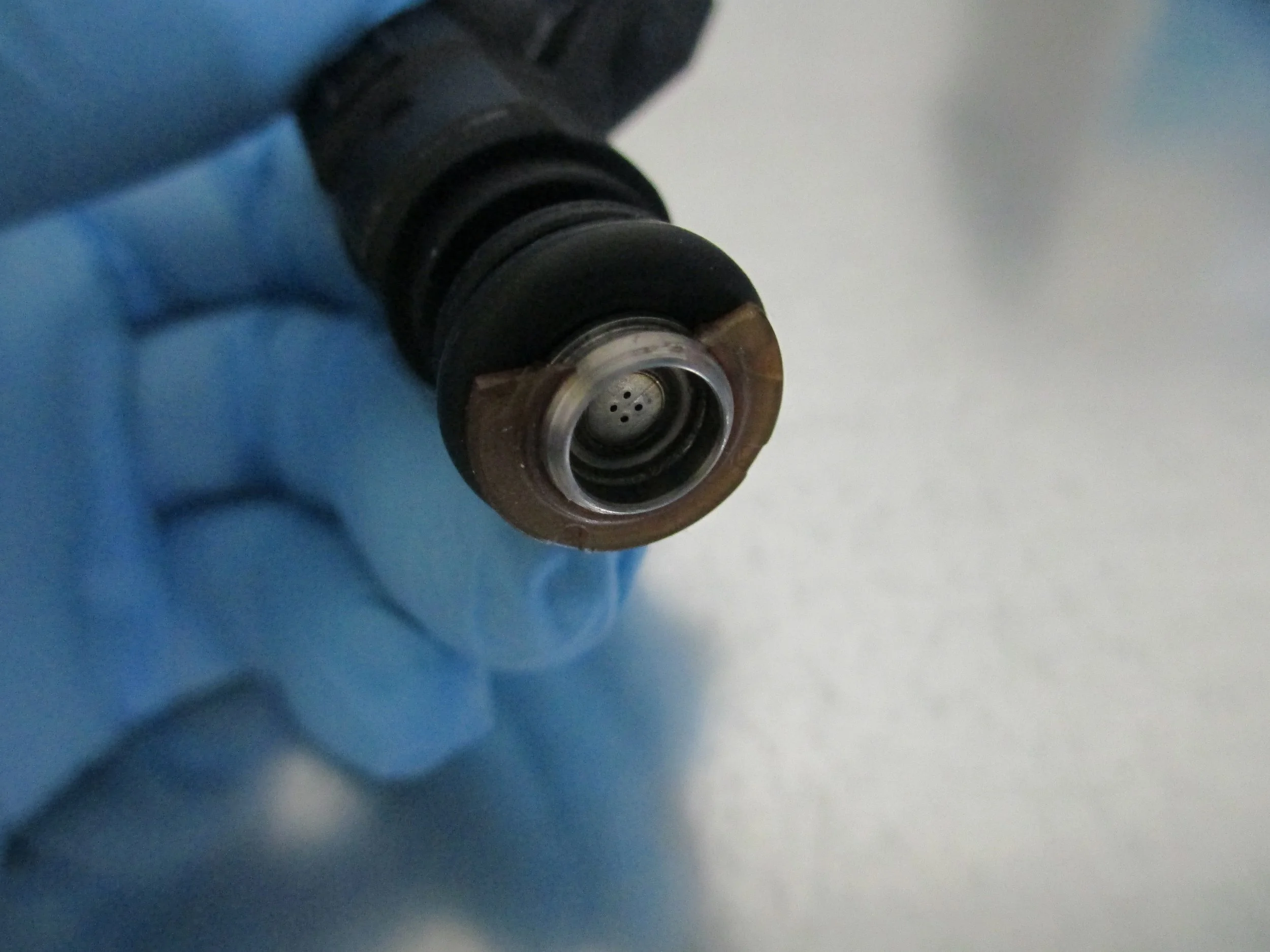Close-up of a broken injector pintle cap from shipping.