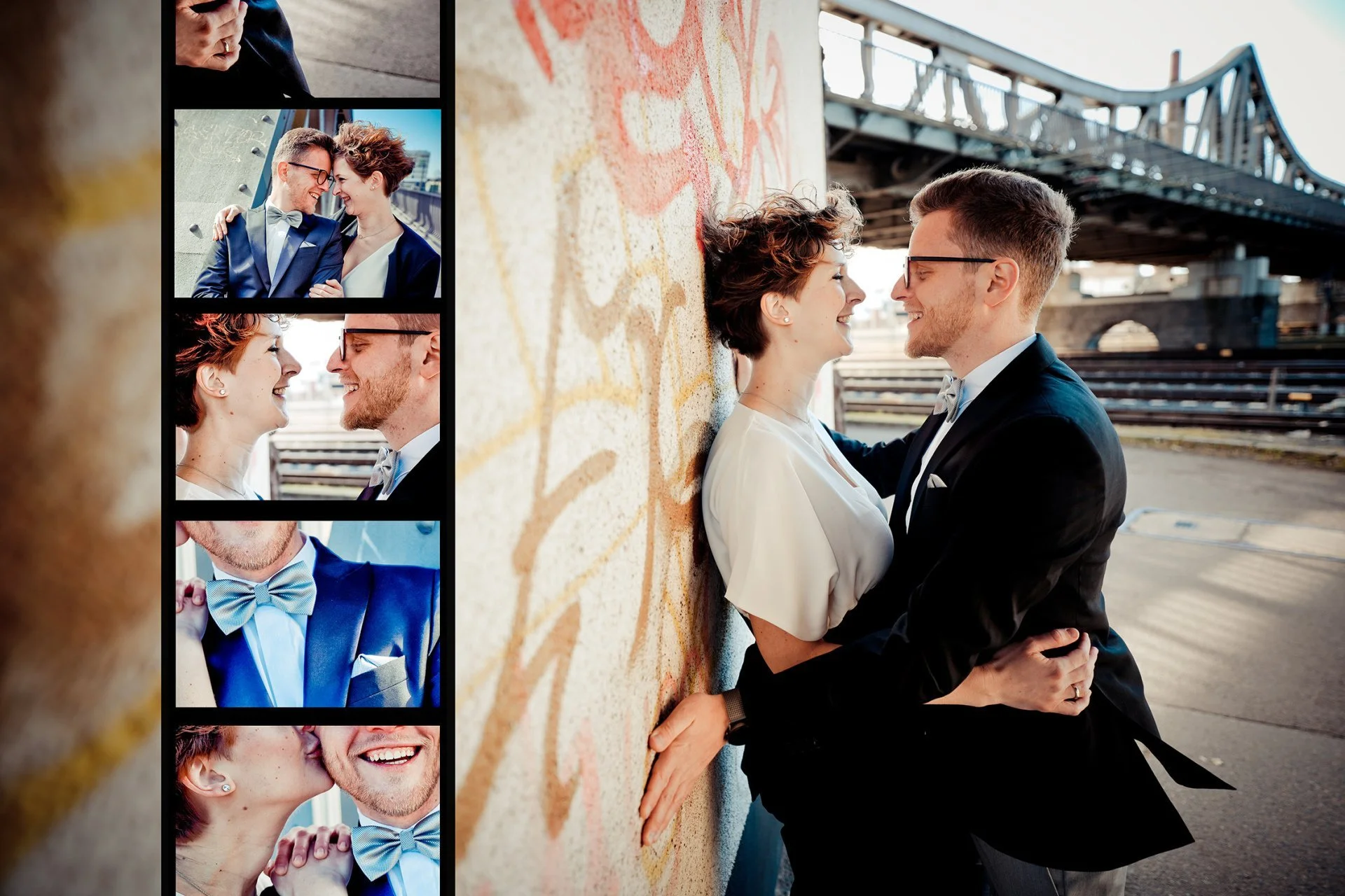 Ein Paar in formeller Kleidung steht vor einer Wand mit Graffiti, dabei lächeln sie sich liebevoll an und stehen sehr nah beieinander.