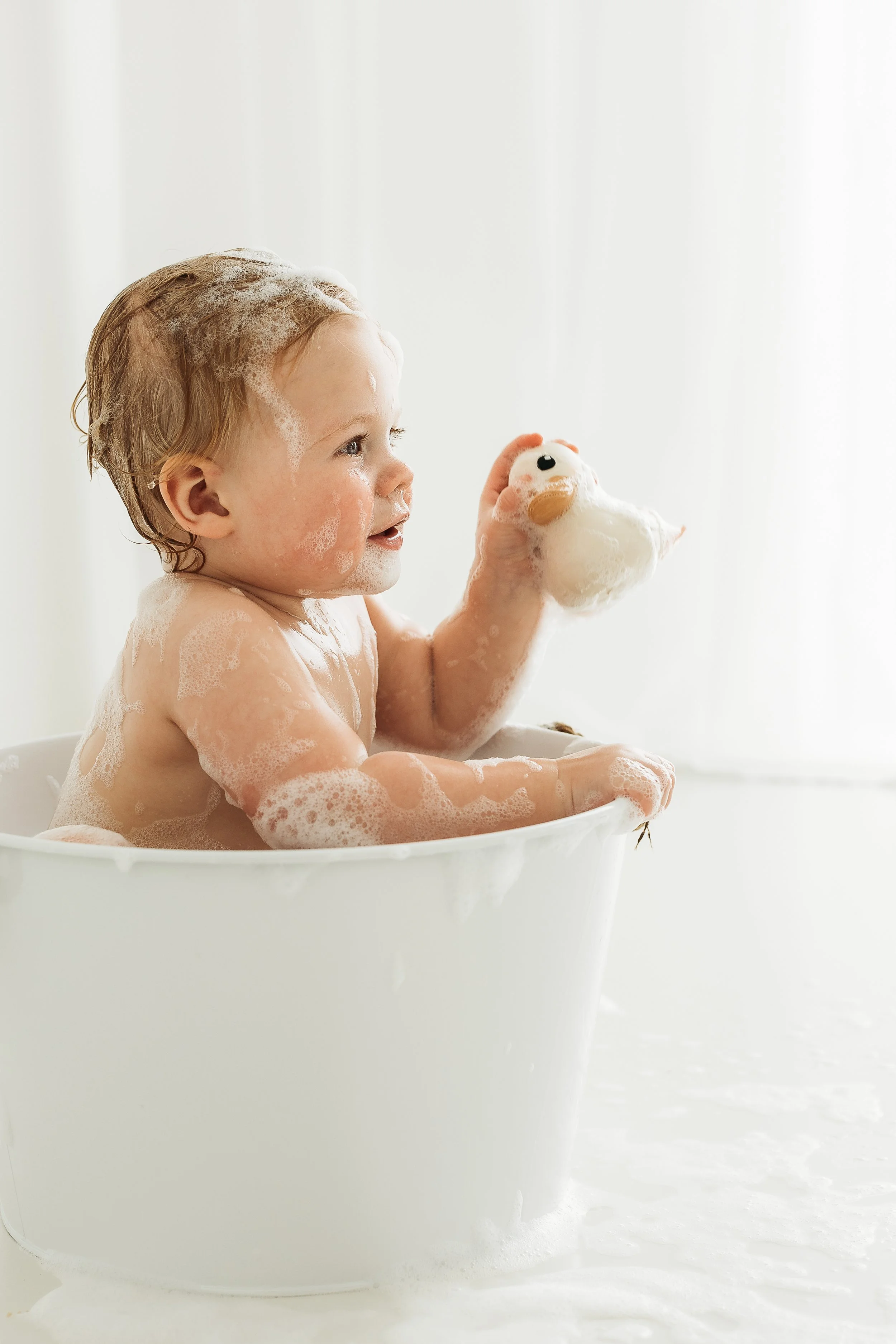 A little one enjoying a playful moment during their first birthday celebration, capturing personality and the joy of being one.