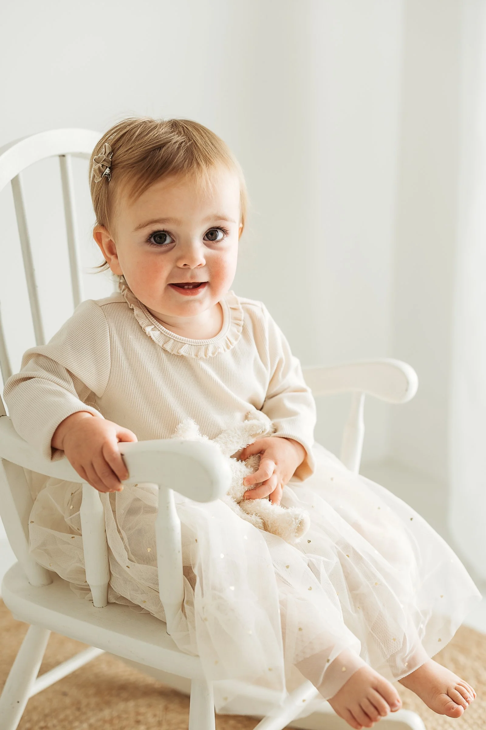 A little one celebrating her own personality and childhood, capturing a sweet milestone moment filled with curiosity and joy.