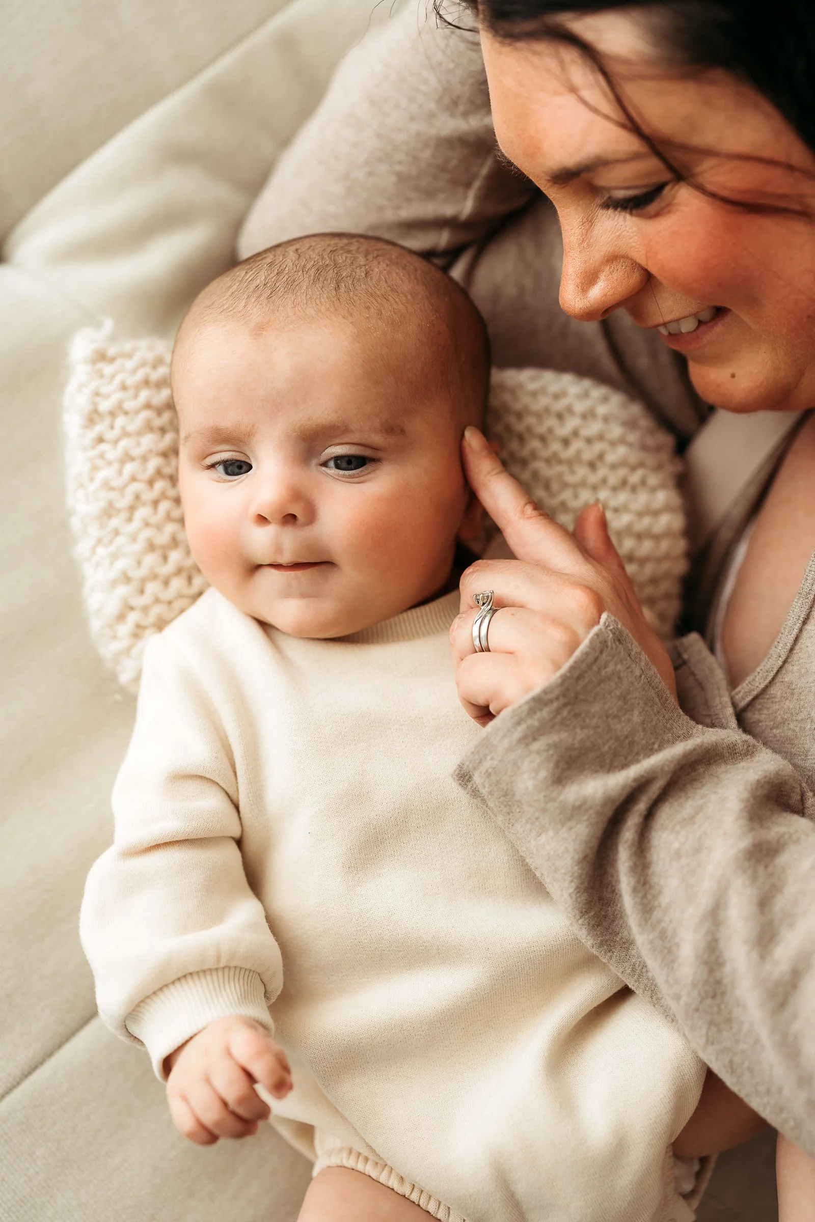 A gentle mother and baby moment, capturing the little details, connection and affection that make these fleeting days so precious.