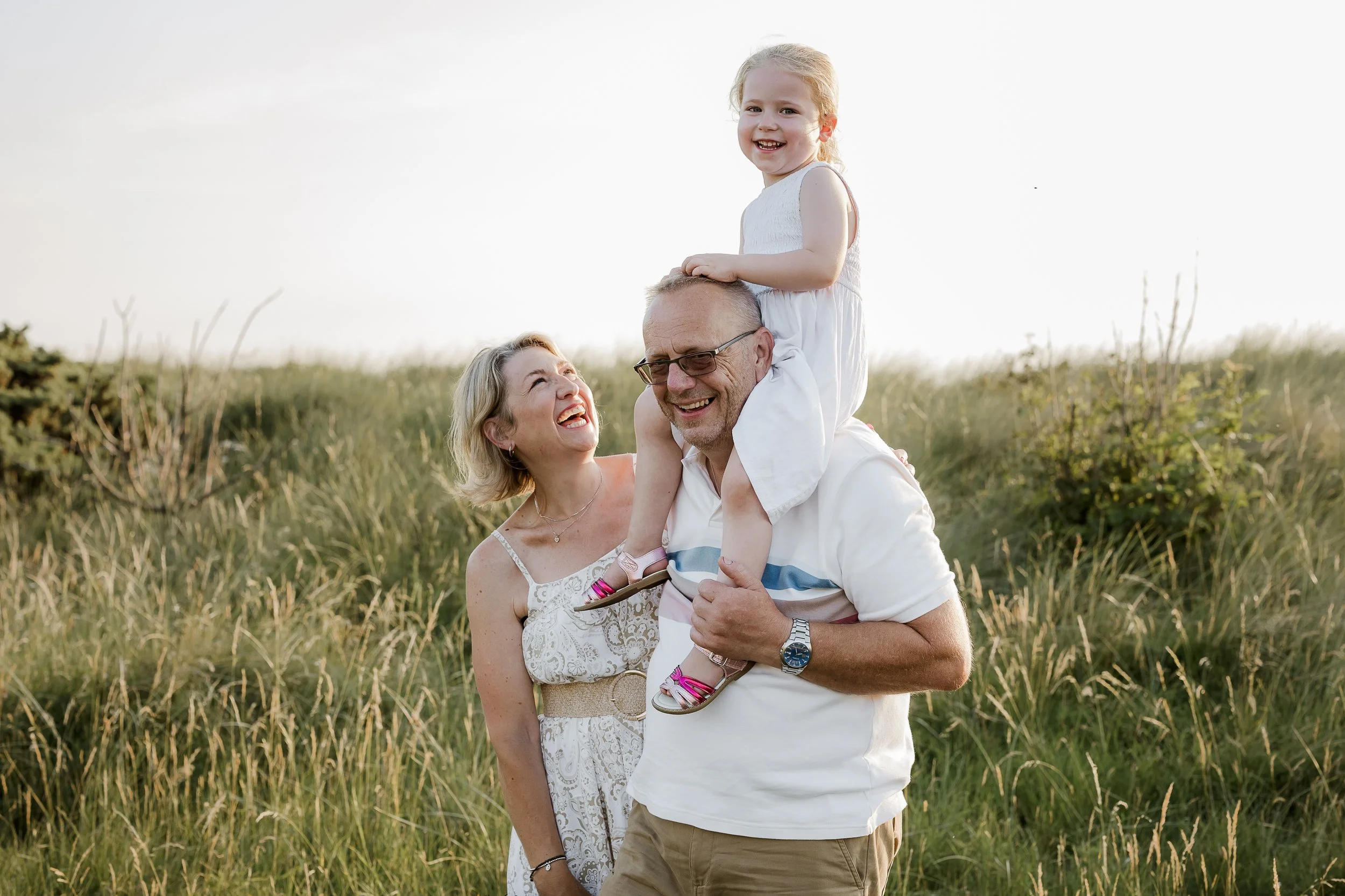 A grandfather sharing a special moment with his granddaughter outdoors, capturing the love and connection between generations.