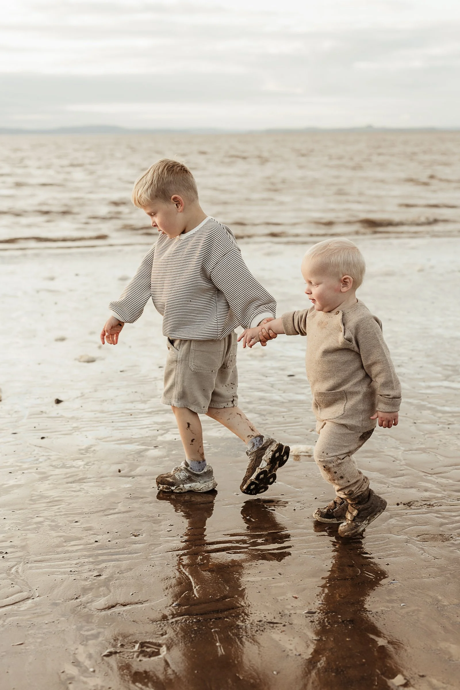 Two brothers exploring the beach together, capturing their connection, adventure and the simple joys of childhood.