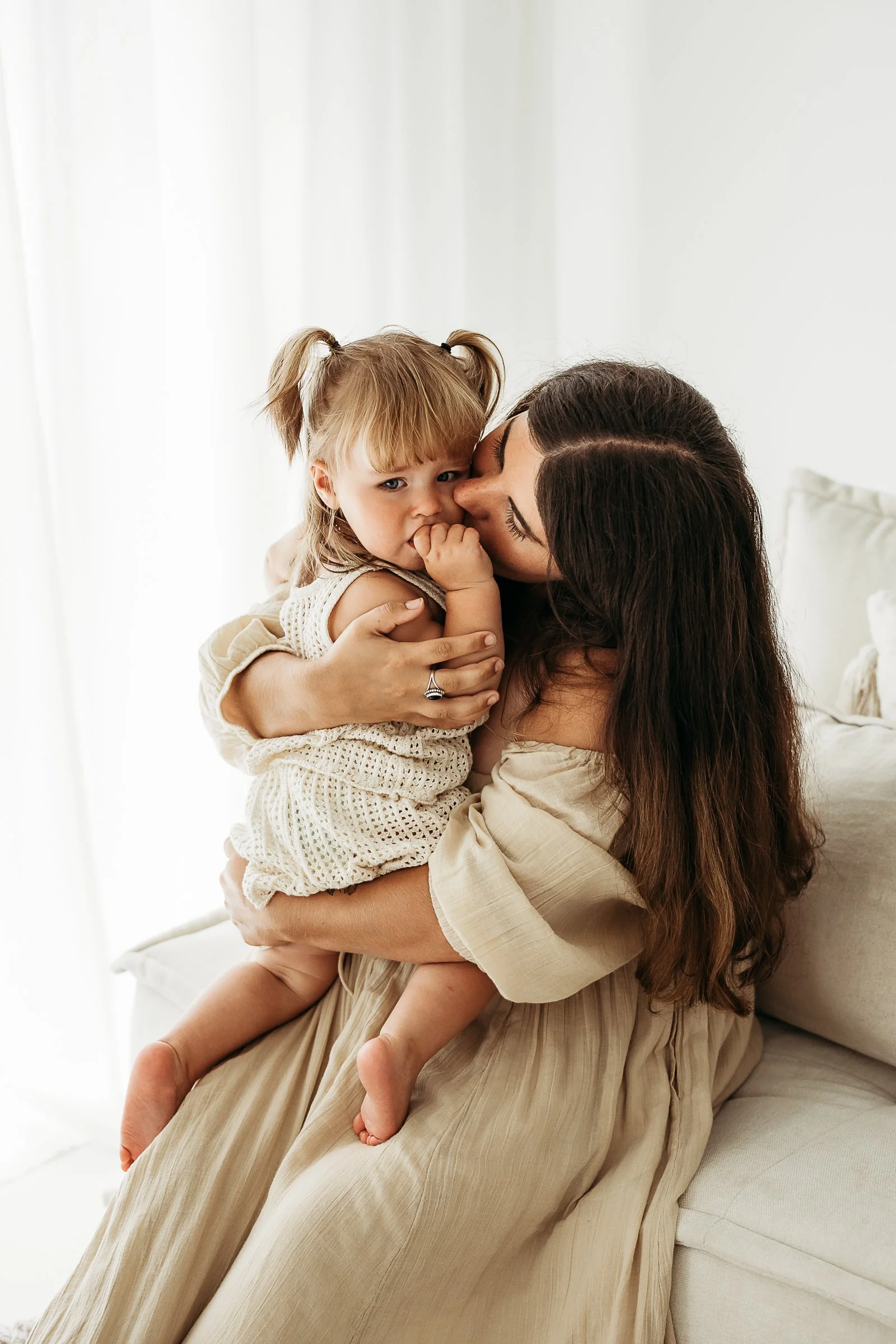 A mother and daughter sharing a tender moment together, capturing the closeness, affection and bond between them.