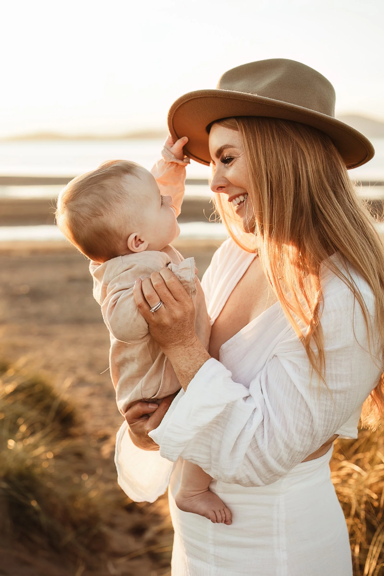 A mother and child sharing a beautiful golden hour moment outdoors, capturing the closeness, love and connection between them.