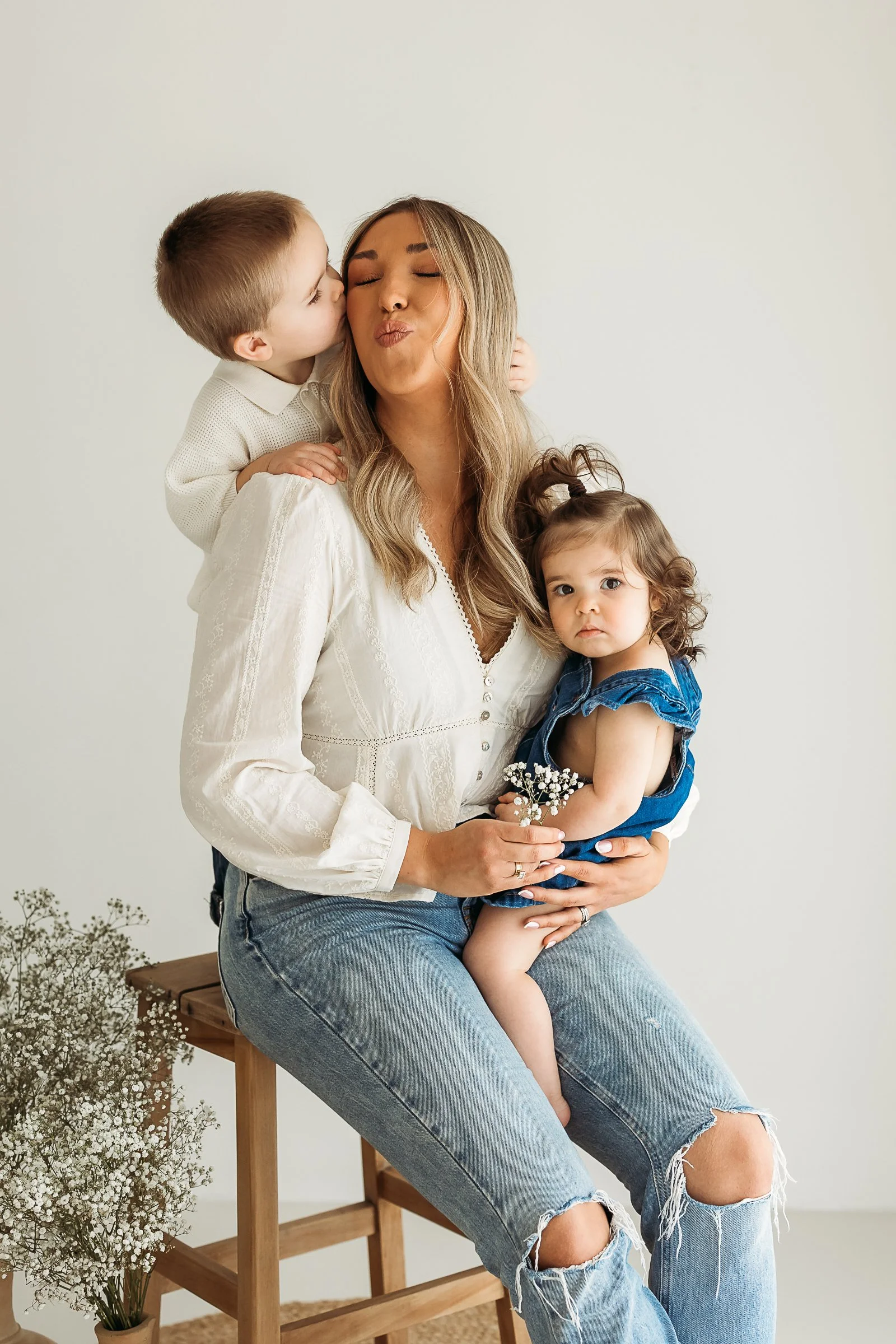 Mum cuddling her two children during a relaxed family studio session.