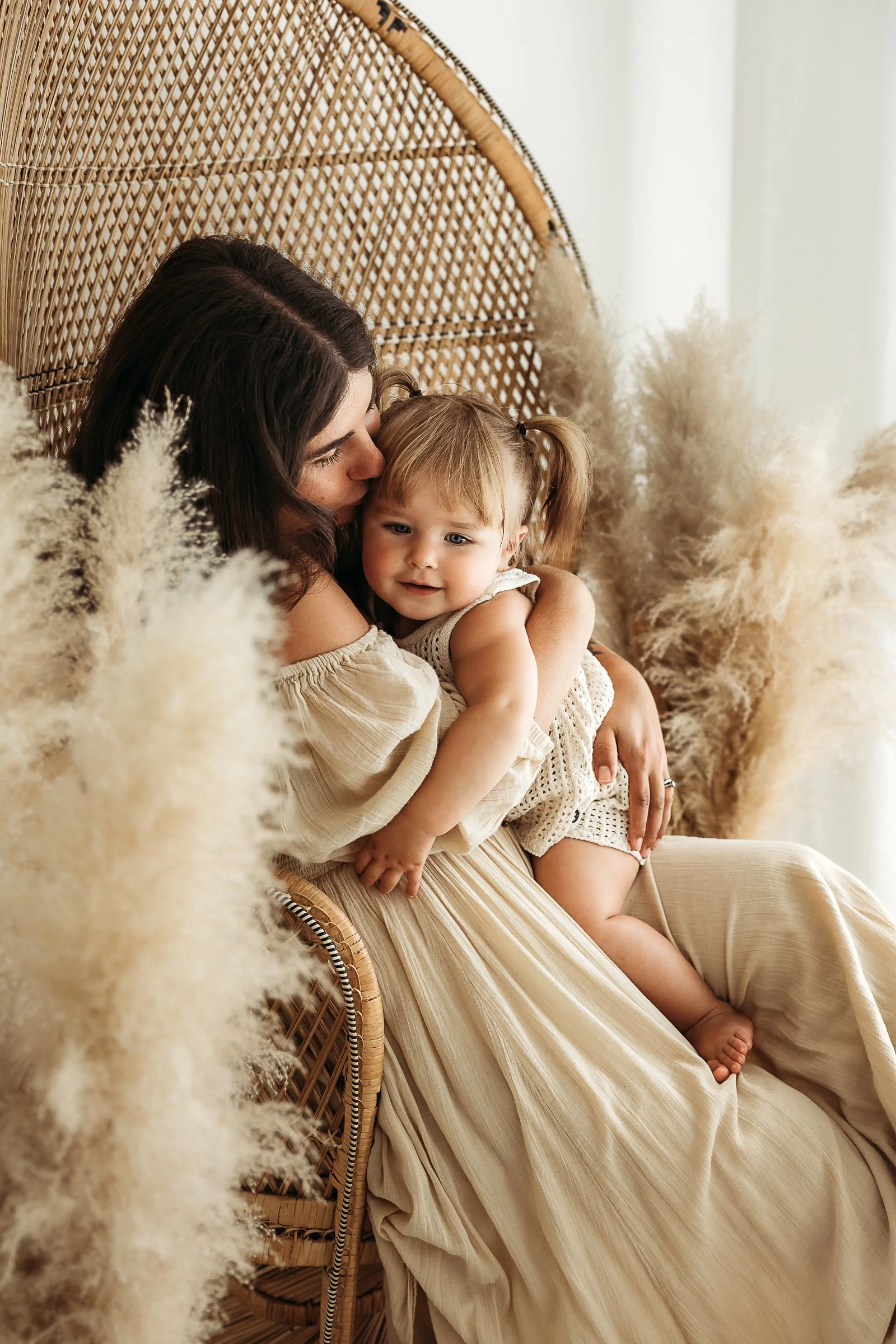 A mother and daughter sharing a quiet, affectionate moment together during a natural family photography session