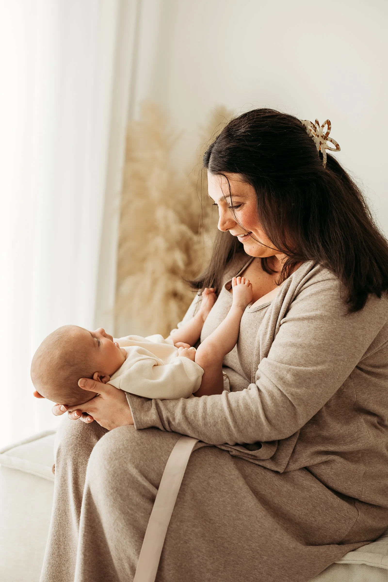A quiet moment between mother and baby, capturing the love, tenderness and closeness of early parenthood.