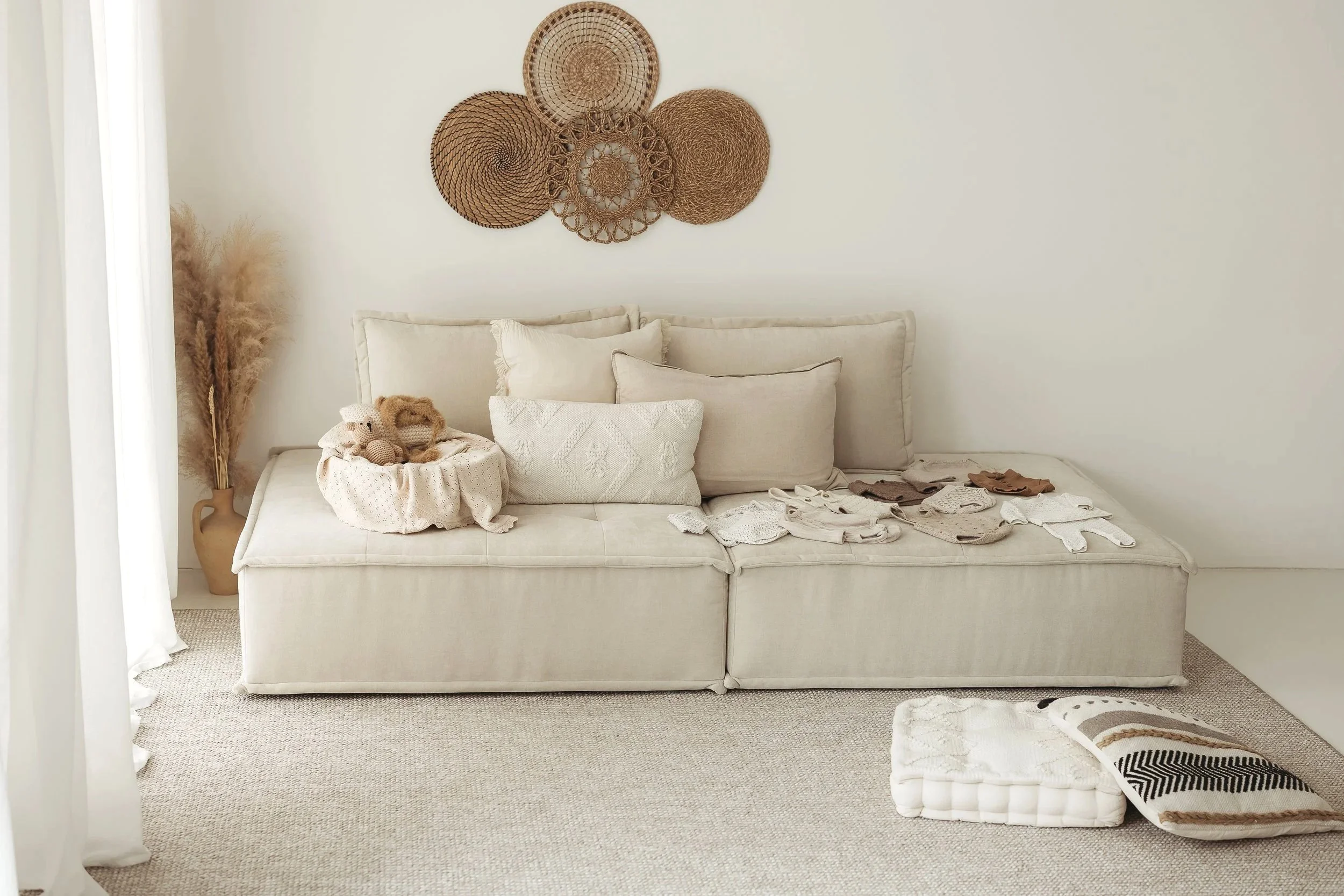 Natural light photography studio in Silloth, Cumbria, with a neutral sofa and relaxed homelike styling.