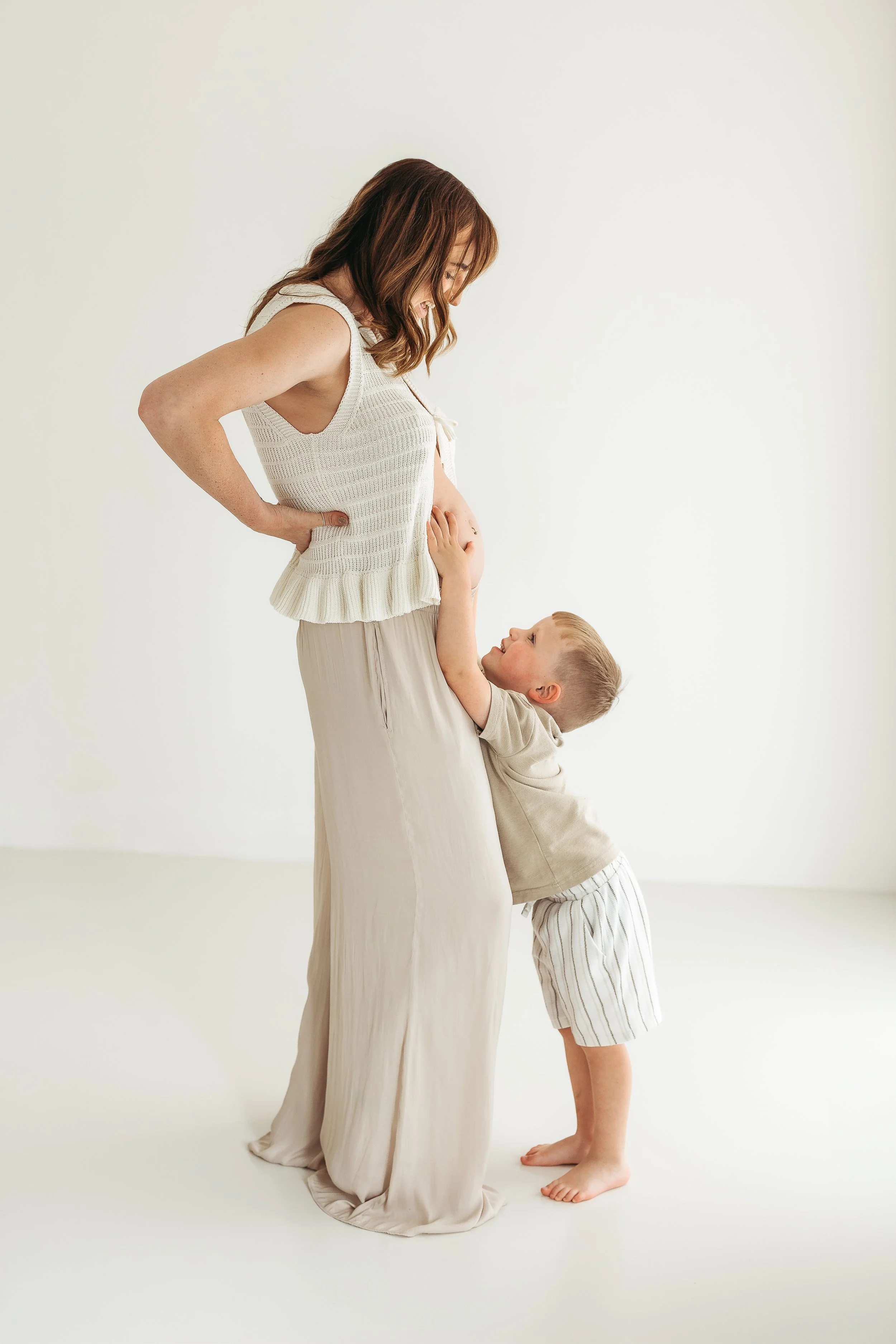 Mother and child sharing a loving moment during a natural maternity photography session.