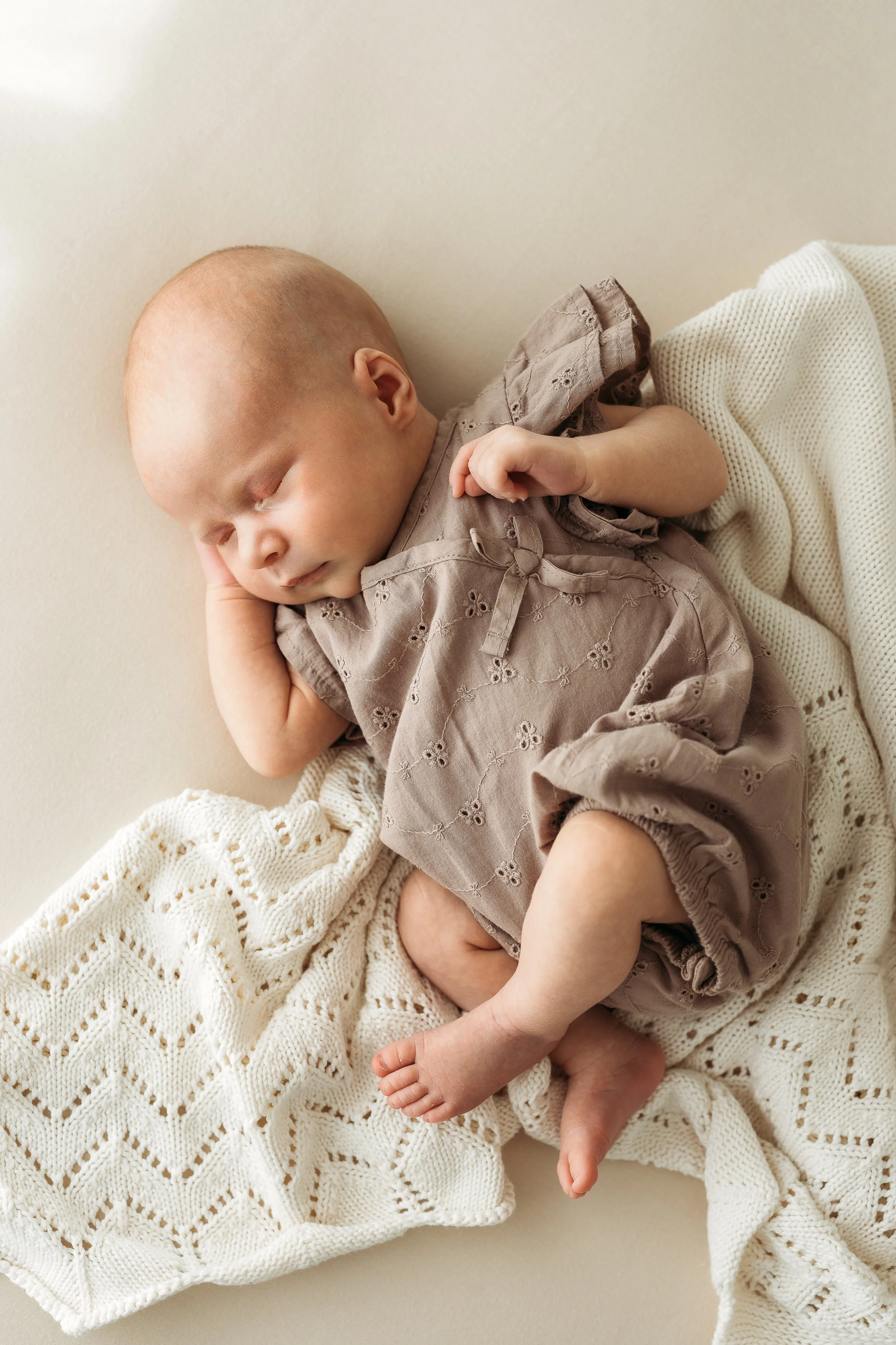 Sleeping newborn baby photographed with soft details during a calm newborn photography session.