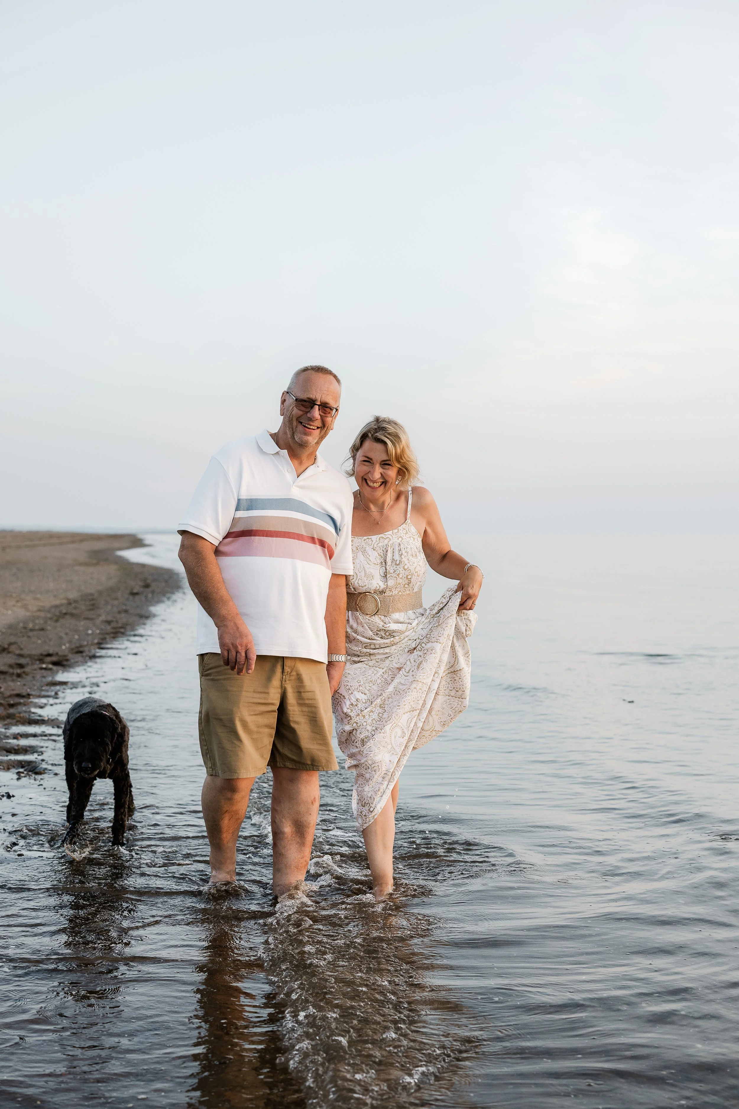 A couple enjoying a peaceful beach walk with their dog, celebrating the love, companionship and everyday moments that matter.