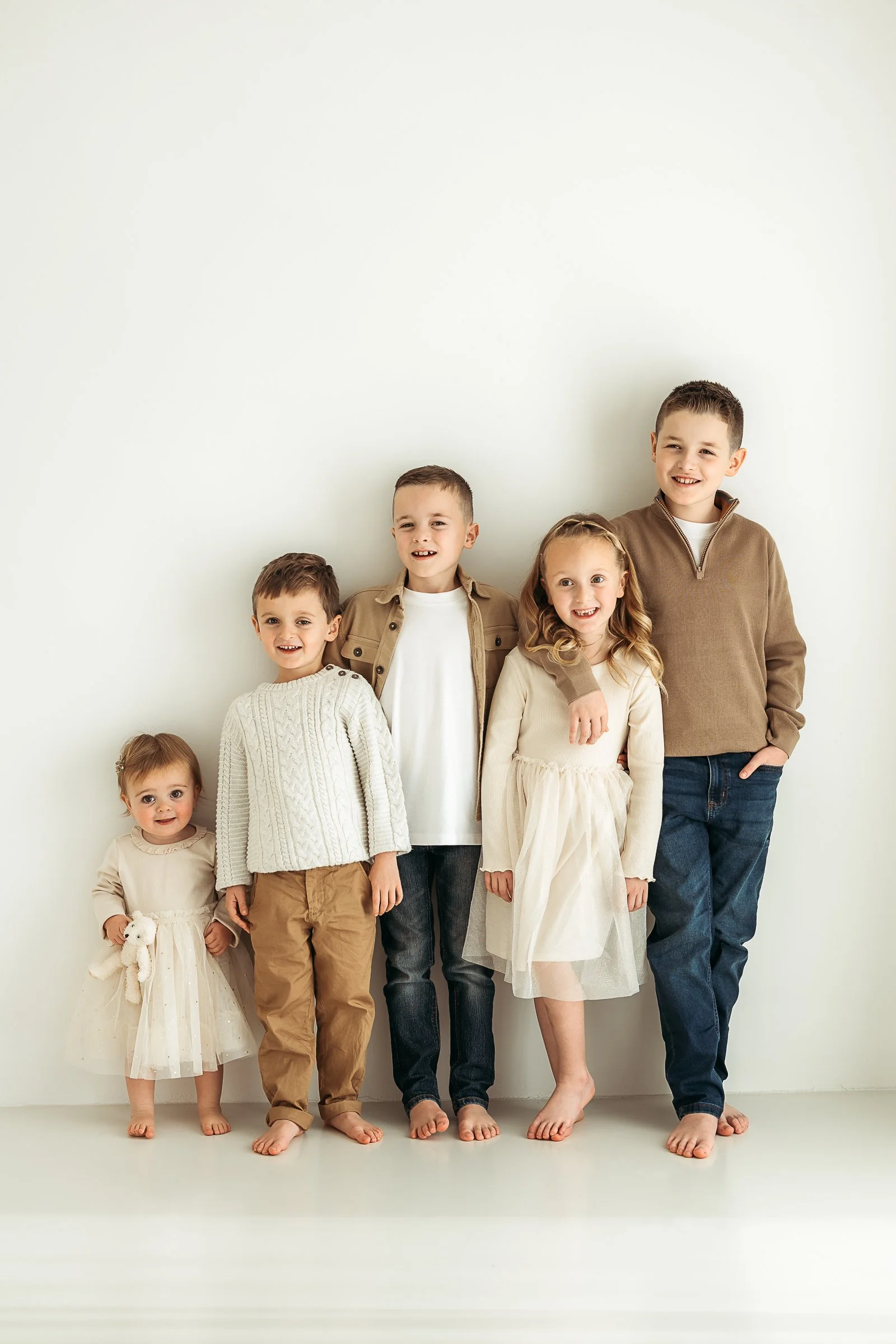 A group of children sharing a fun and relaxed moment together, capturing their personalities, friendships and childhood memories.