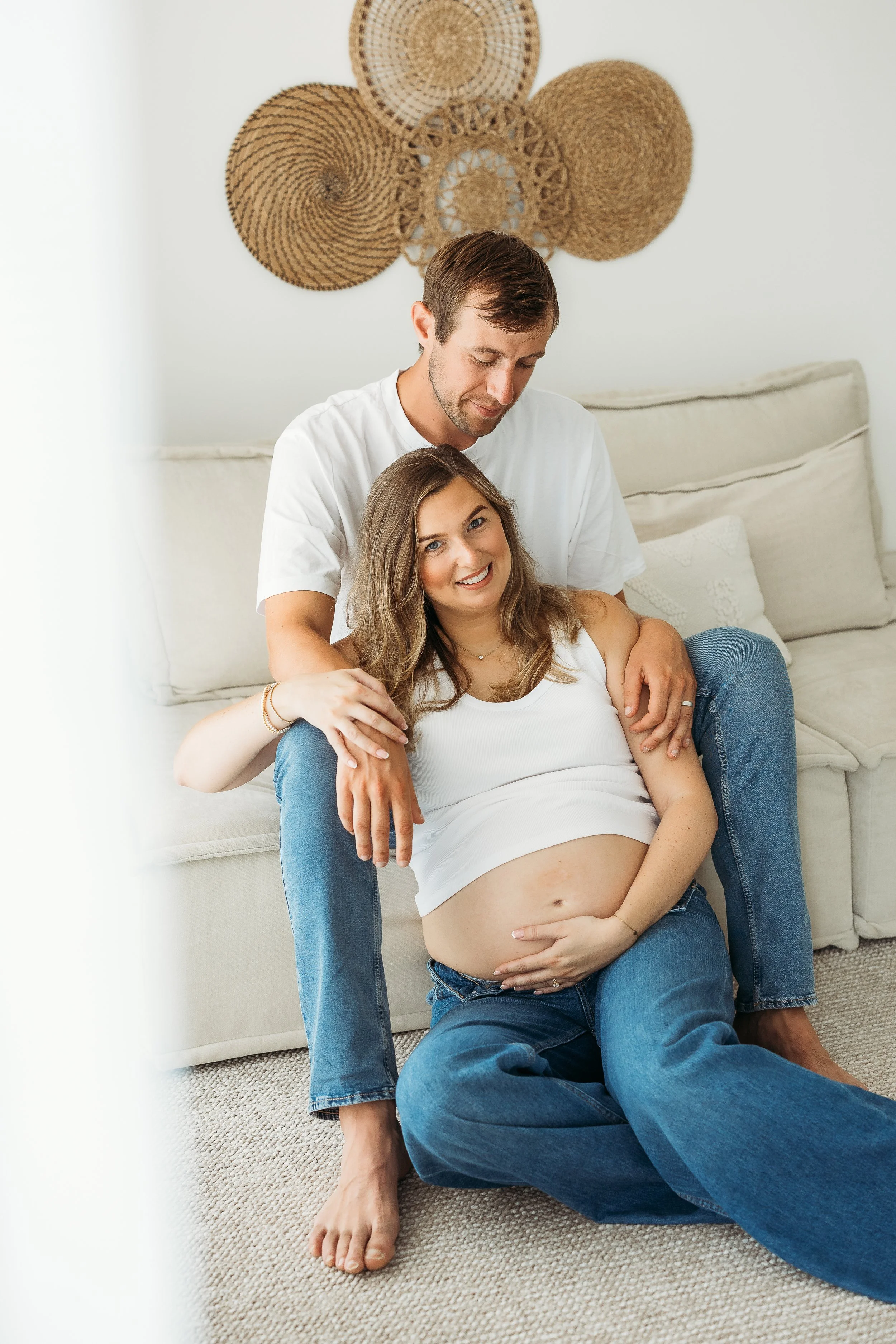 Expecting parents sharing a quiet, affectionate moment together during a relaxed maternity photography session.