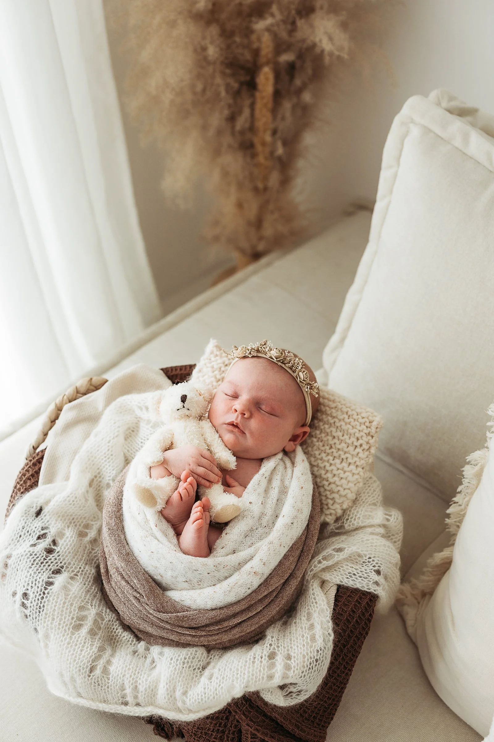 Sleeping newborn baby photographed in a calm, natural newborn photography session.